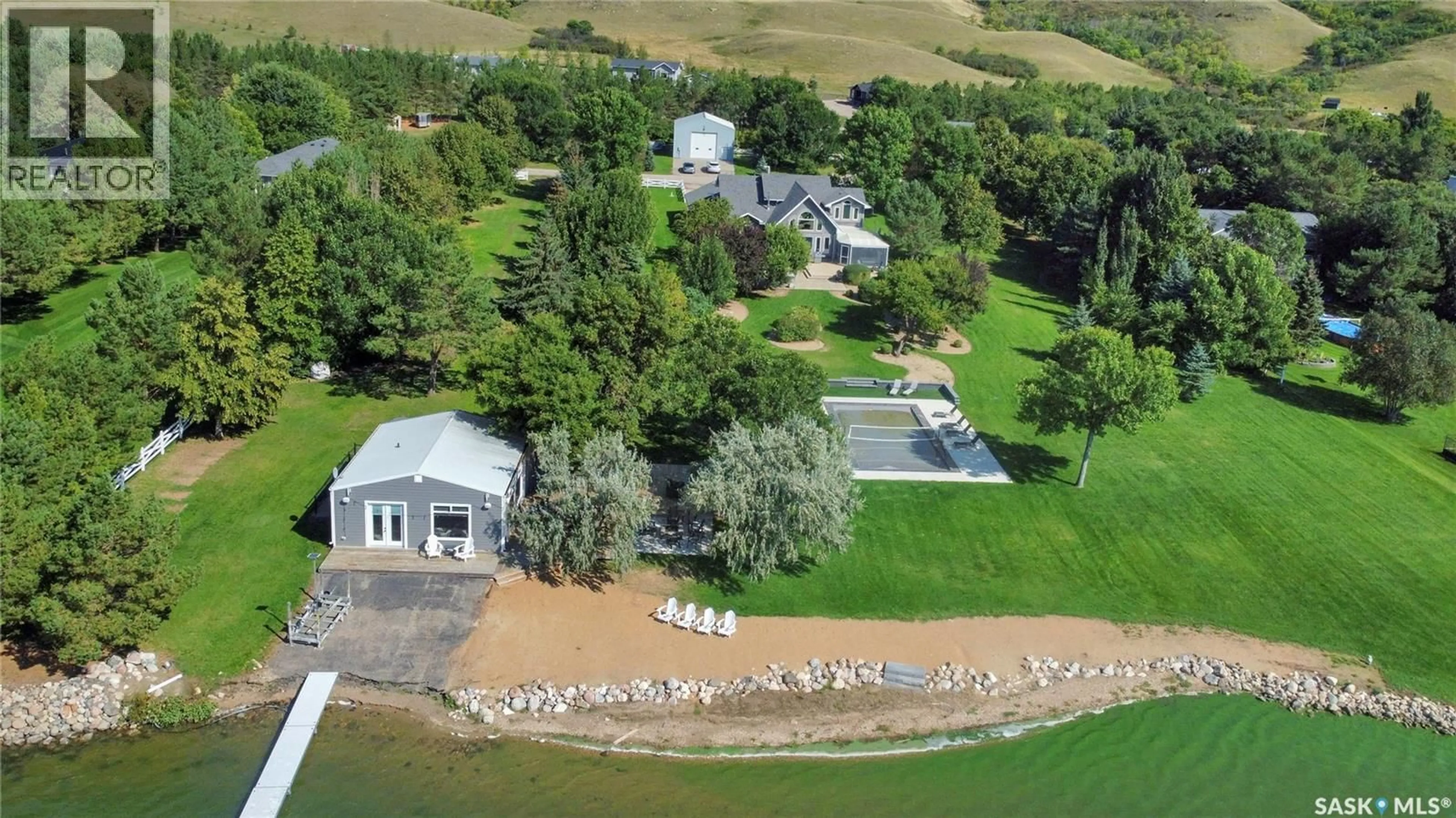 A pic from outside/outdoor area/front of a property/back of a property/a pic from drone, water/lake/river/ocean view for 203 NORTH SHORE DRIVE, North Grove Saskatchewan S0G1P0