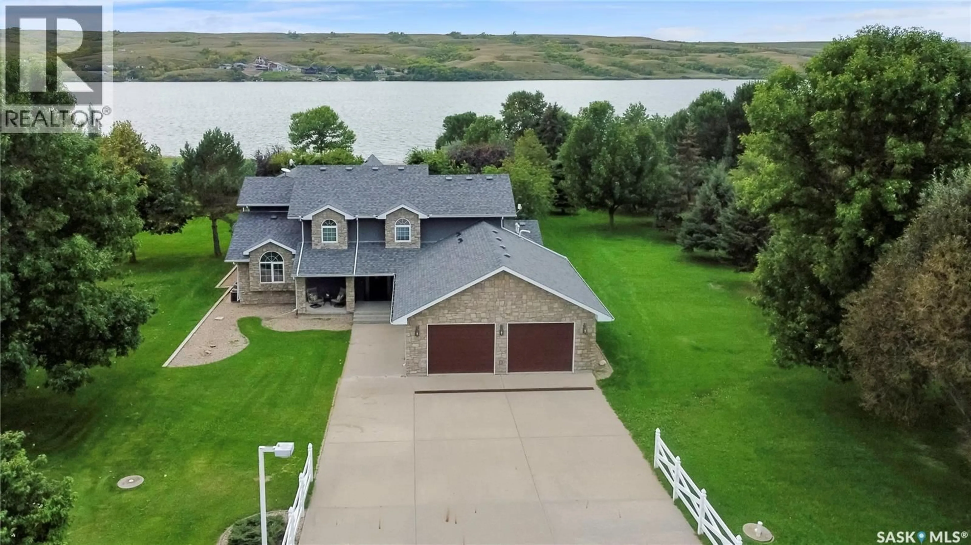 A pic from outside/outdoor area/front of a property/back of a property/a pic from drone, water/lake/river/ocean view for 203 NORTH SHORE DRIVE, North Grove Saskatchewan S0G1P0