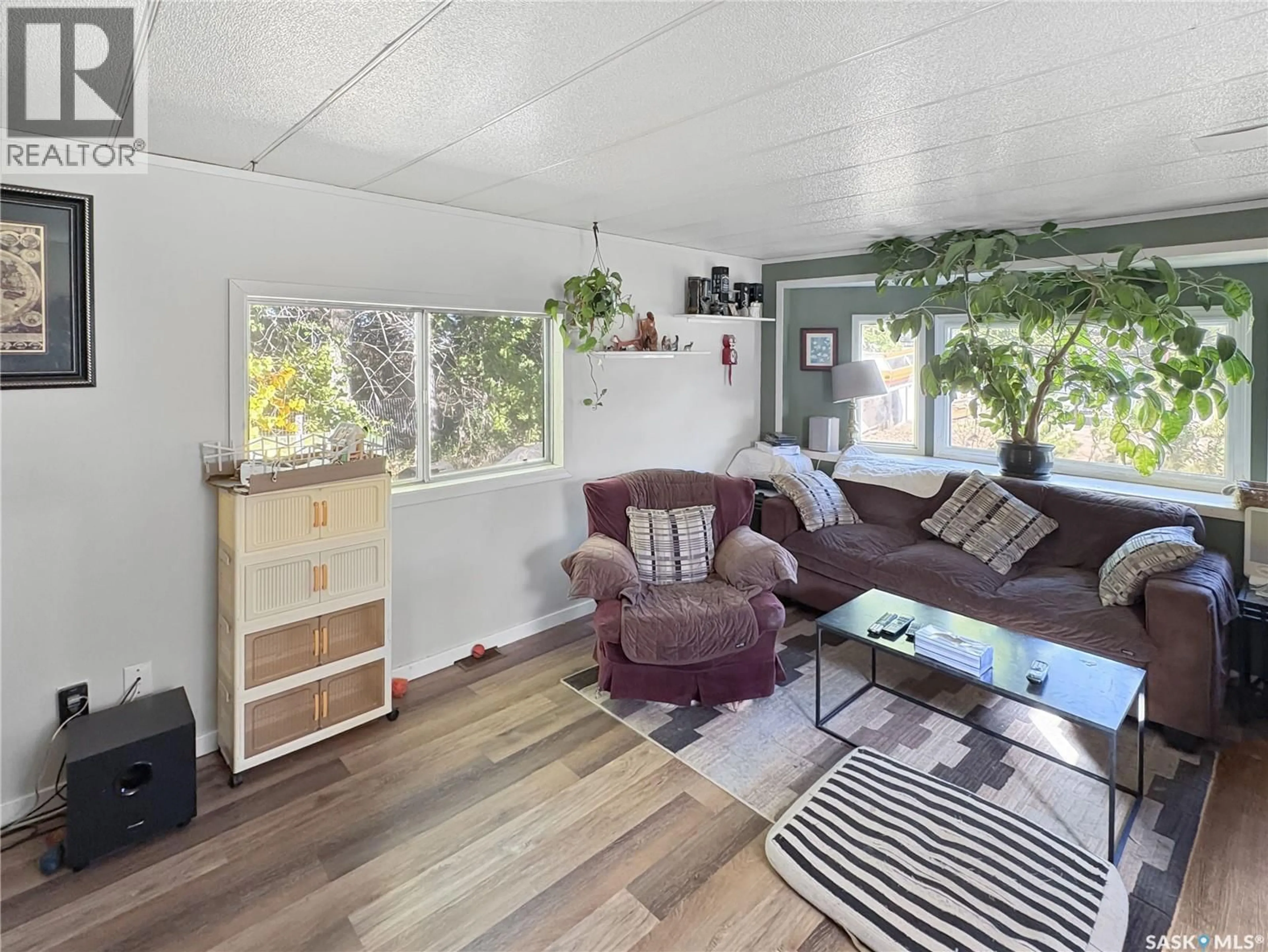 Living room with furniture, wood/laminate floor for 34059 RGE RD 3074 ACREAGE, Vanscoy Rm No. 345 Saskatchewan S7K1N2
