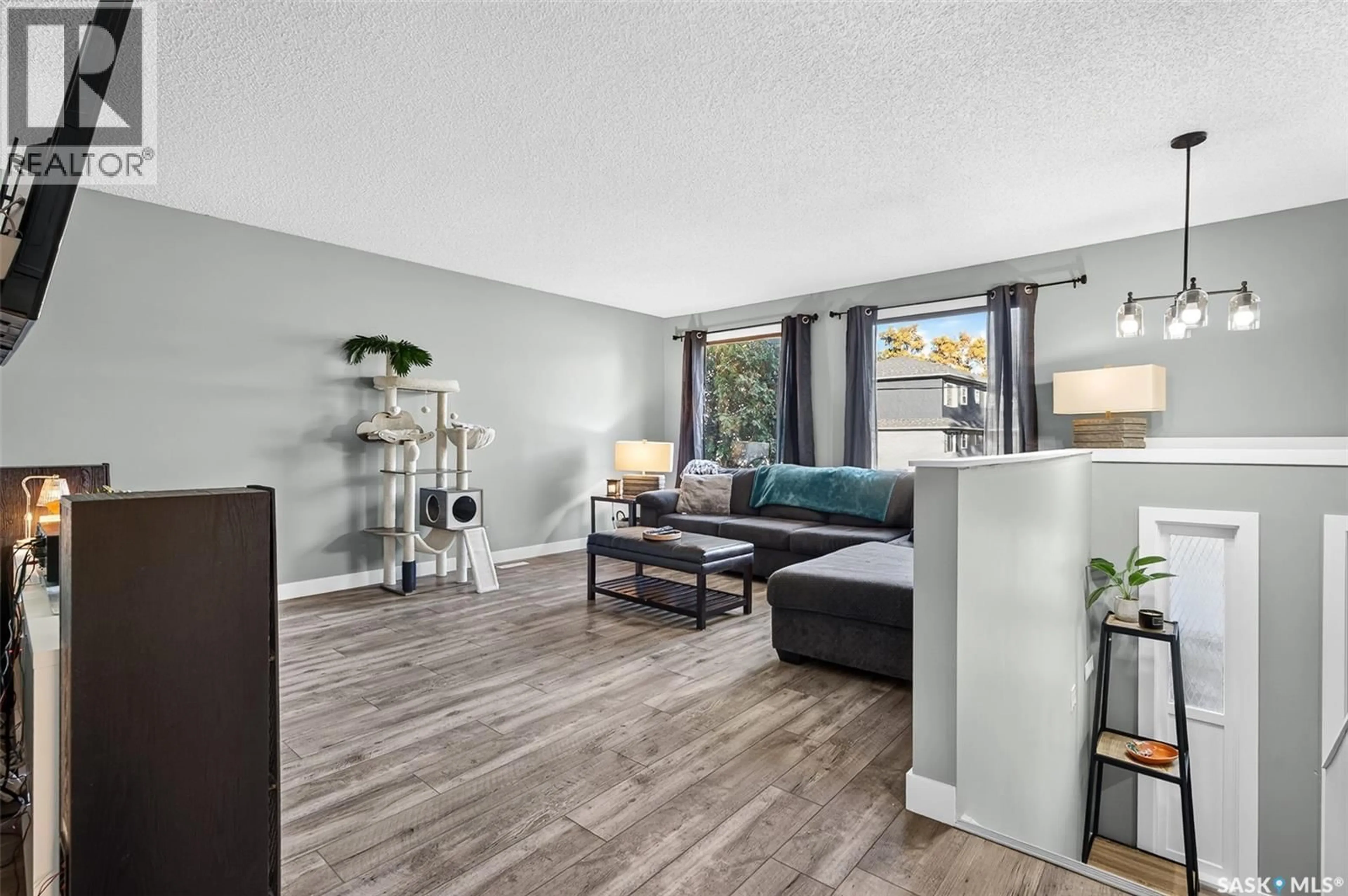Living room with furniture, wood/laminate floor for 1010 9TH AVENUE, Moose Jaw Saskatchewan S6H5X5