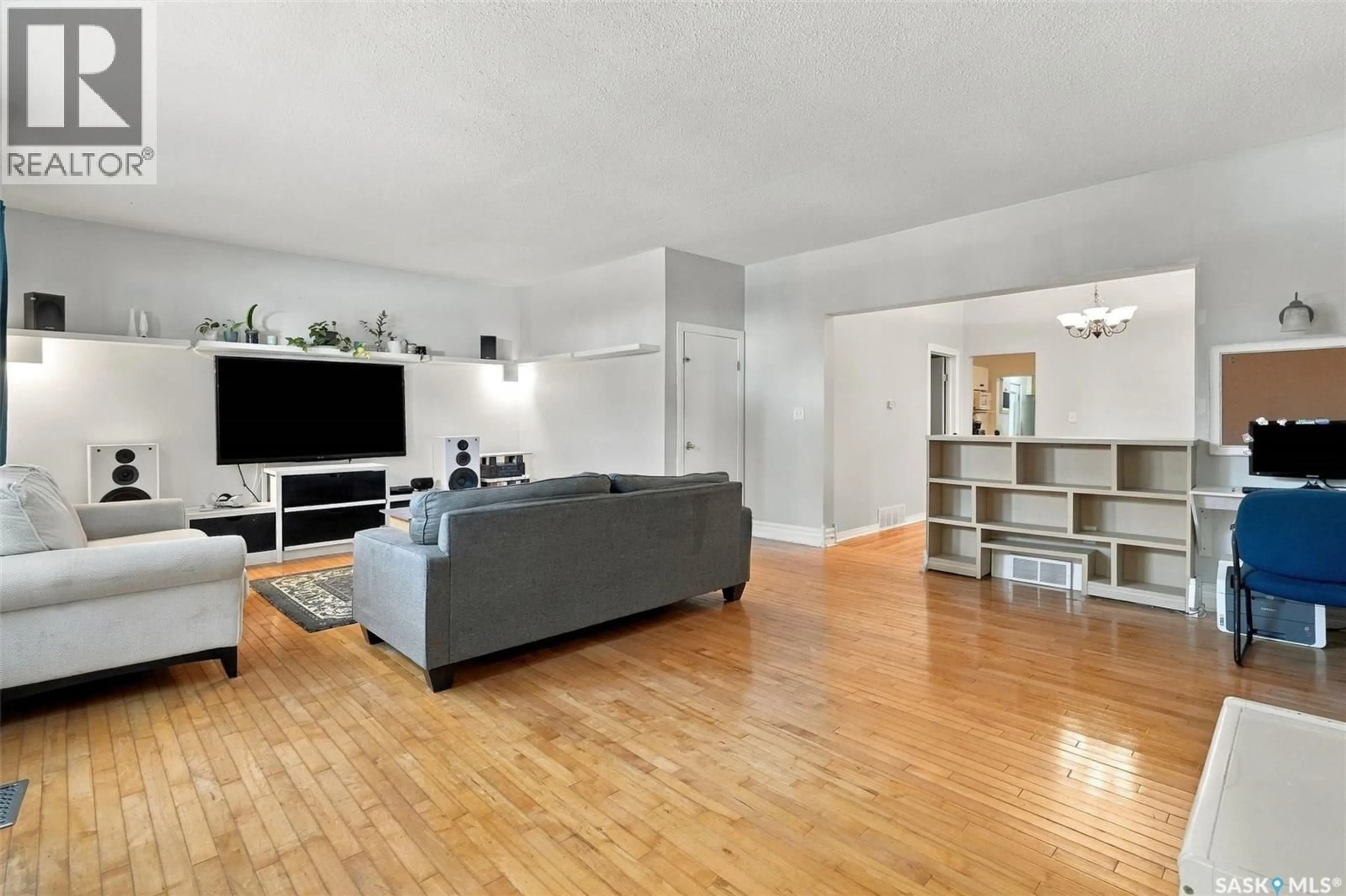 Living room with furniture, wood/laminate floor for 2100 LINDSAY STREET, Regina Saskatchewan S4N3B9