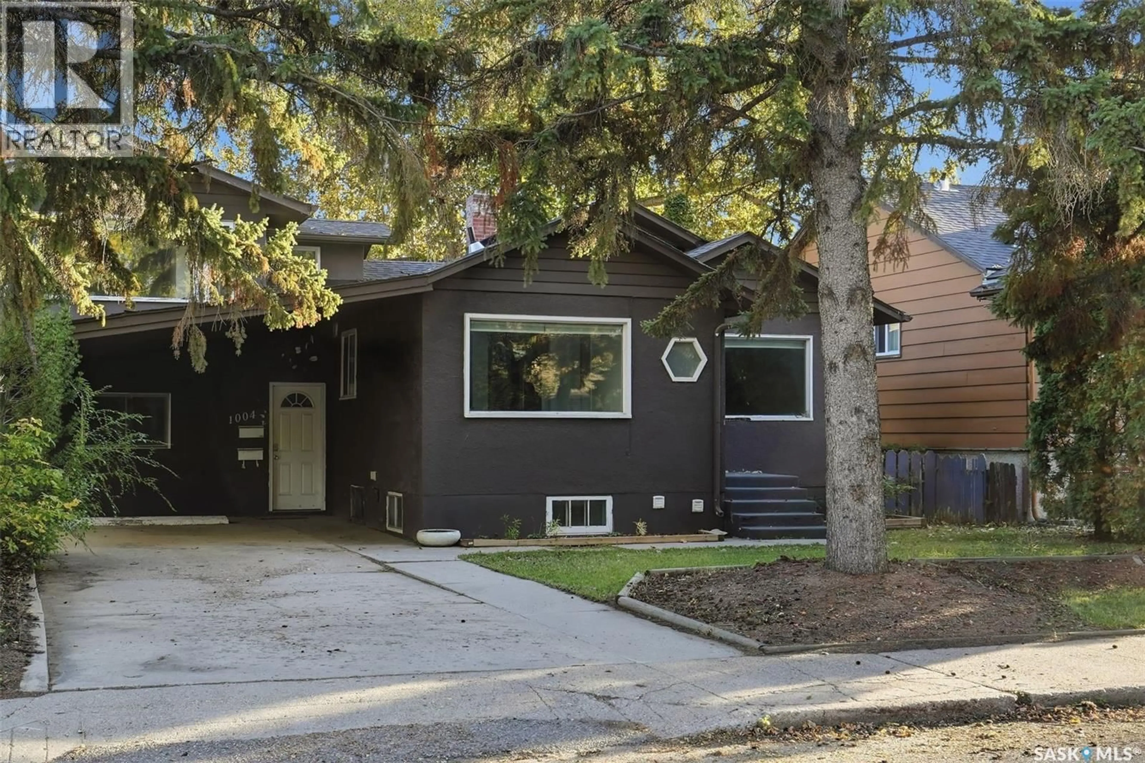 Home with vinyl exterior material, street for 1004 6TH STREET, Saskatoon Saskatchewan S7H1E2