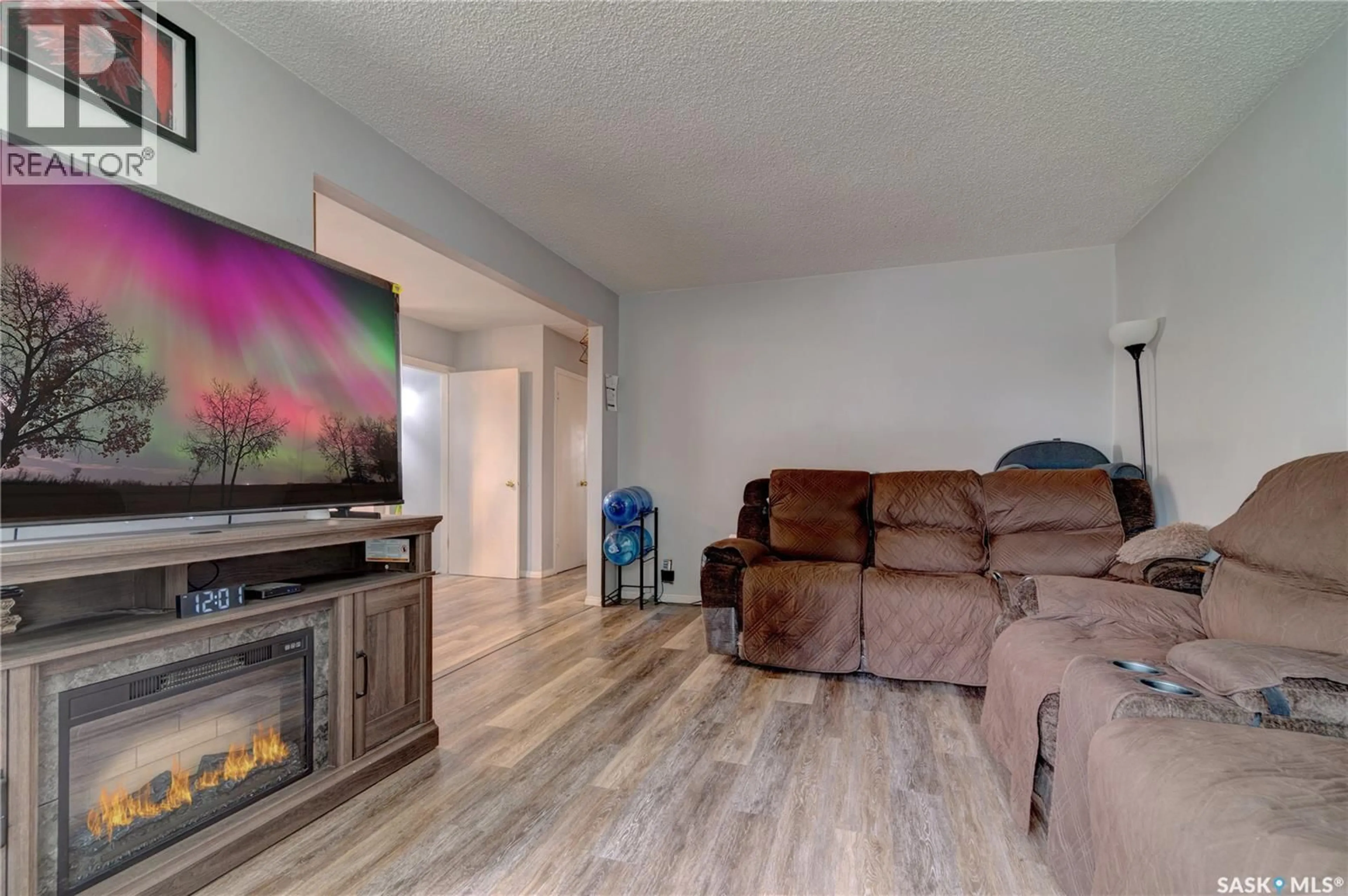 Living room with furniture, wood/laminate floor for 245 EDWARD STREET, Regina Saskatchewan S4R4W2