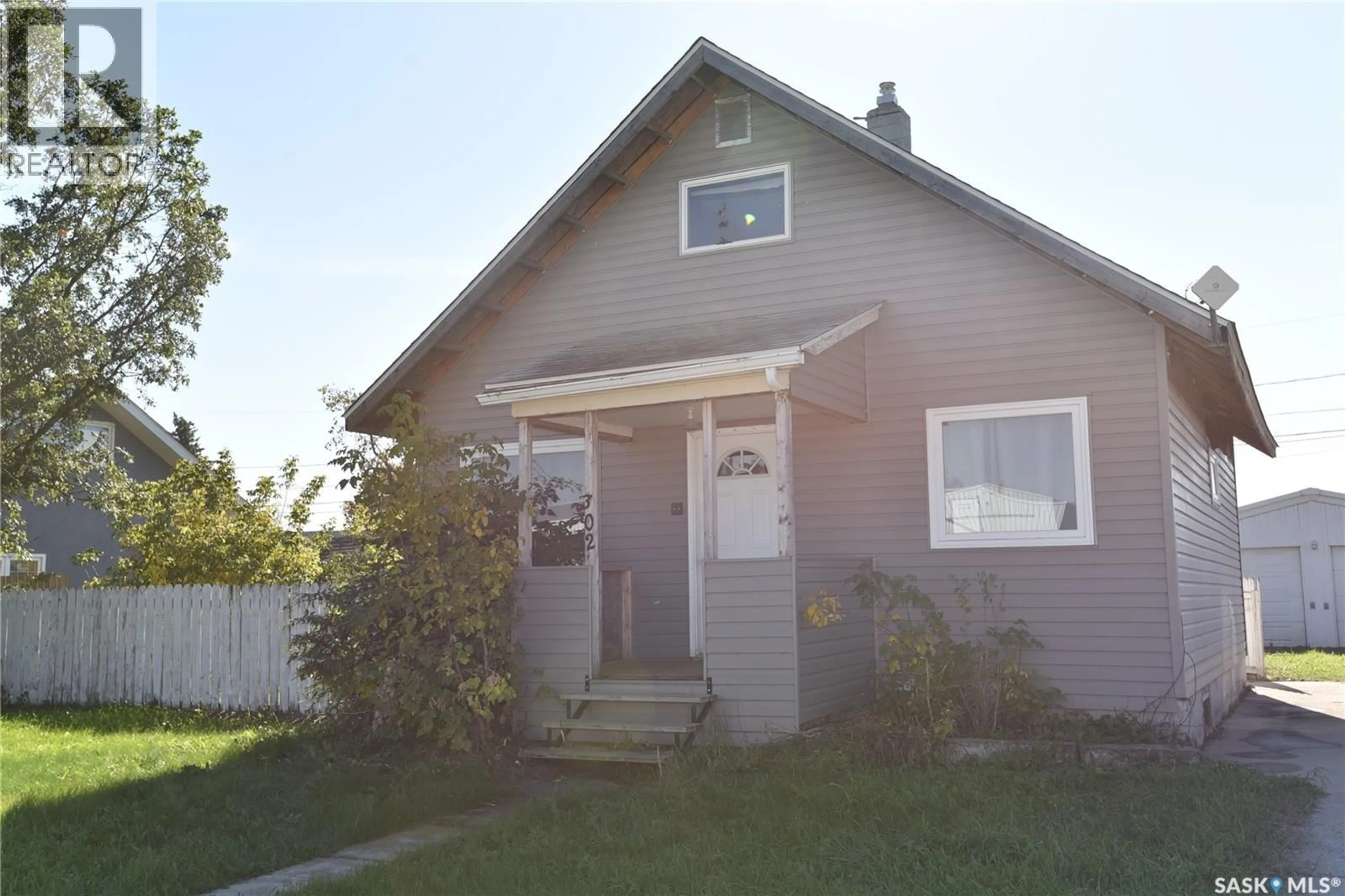 Home with vinyl exterior material, street for 302 CENTRE STREET, Codette Saskatchewan S0P0P0