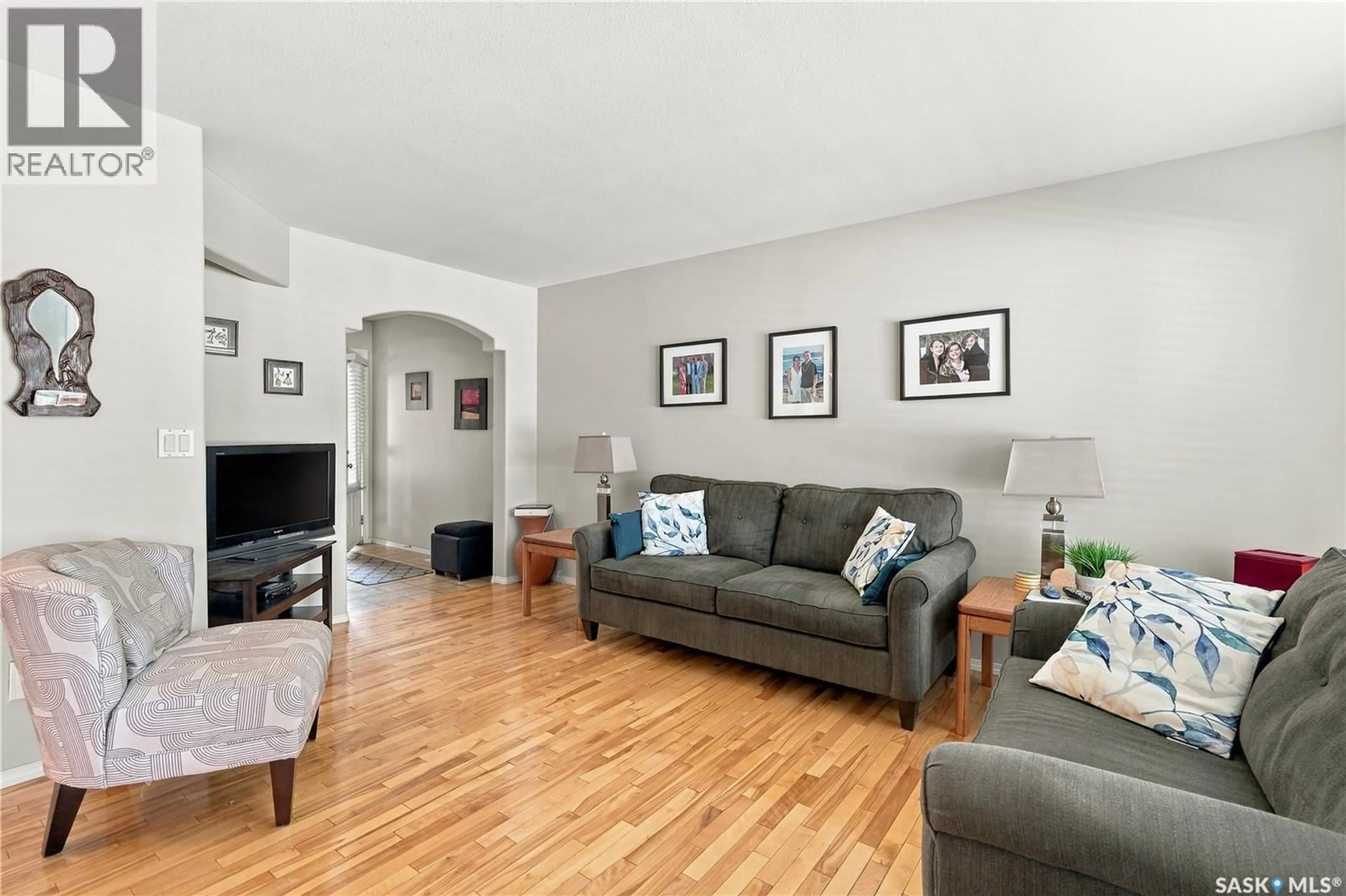 Living room with furniture, wood/laminate floor for 445 - 103 BAYFIELD CRESCENT, Saskatoon Saskatchewan S7V1J1