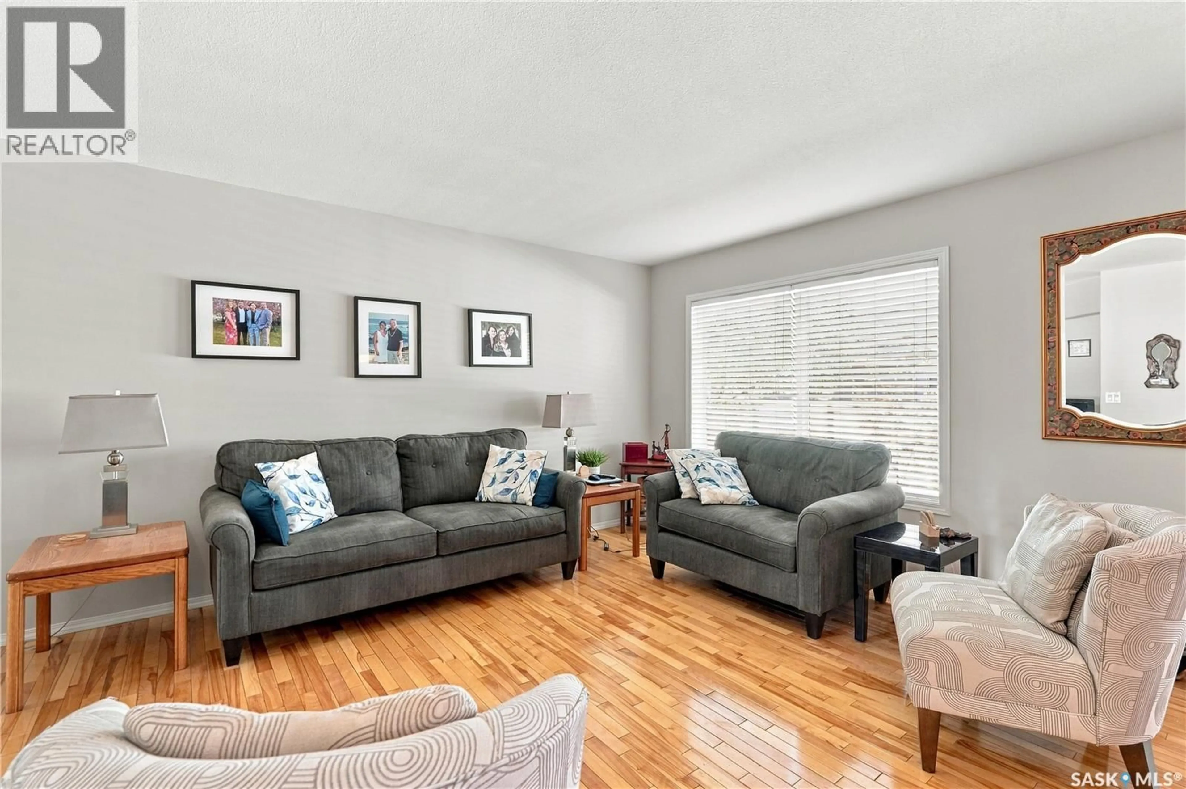 Living room with furniture, wood/laminate floor for 445 - 103 BAYFIELD CRESCENT, Saskatoon Saskatchewan S7V1J1
