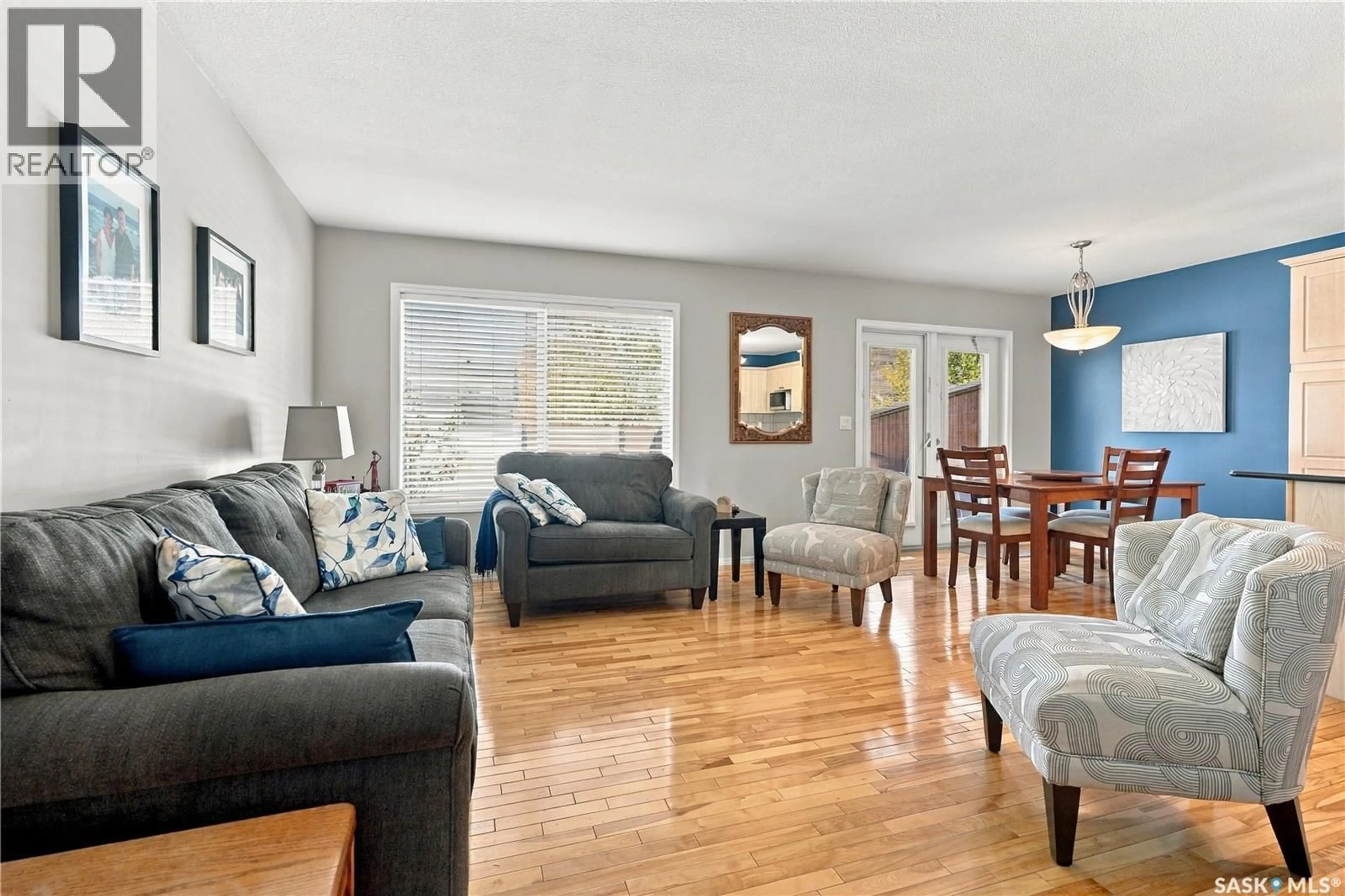 Living room with furniture, wood/laminate floor for 445 - 103 BAYFIELD CRESCENT, Saskatoon Saskatchewan S7V1J1