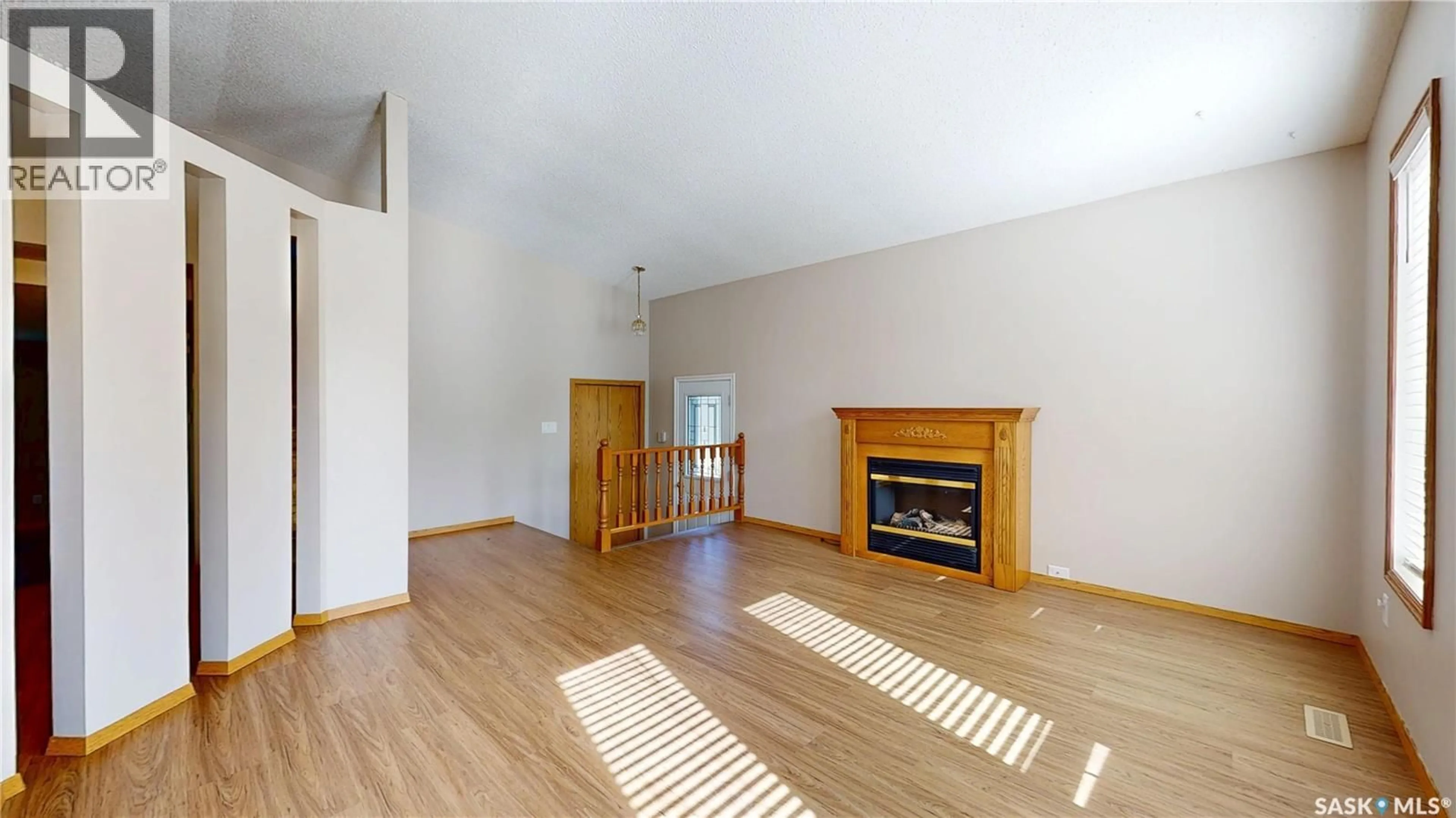 Living room with furniture, wood/laminate floor for 6418 DALGLIESH DRIVE, Regina Saskatchewan S4X2R2
