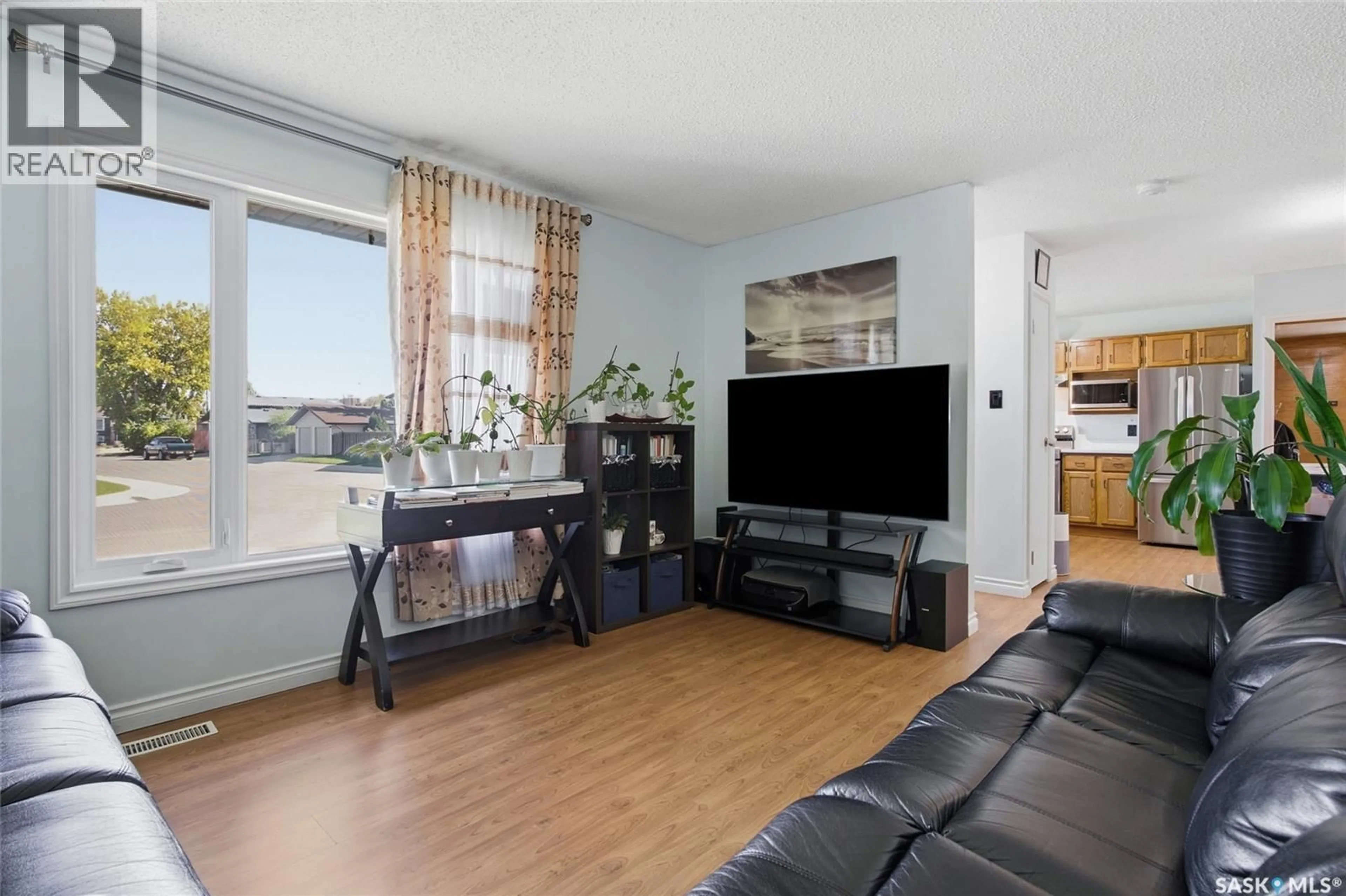 Living room with furniture, wood/laminate floor for 403 SHERRY CRESCENT, Saskatoon Saskatchewan S7M5R9