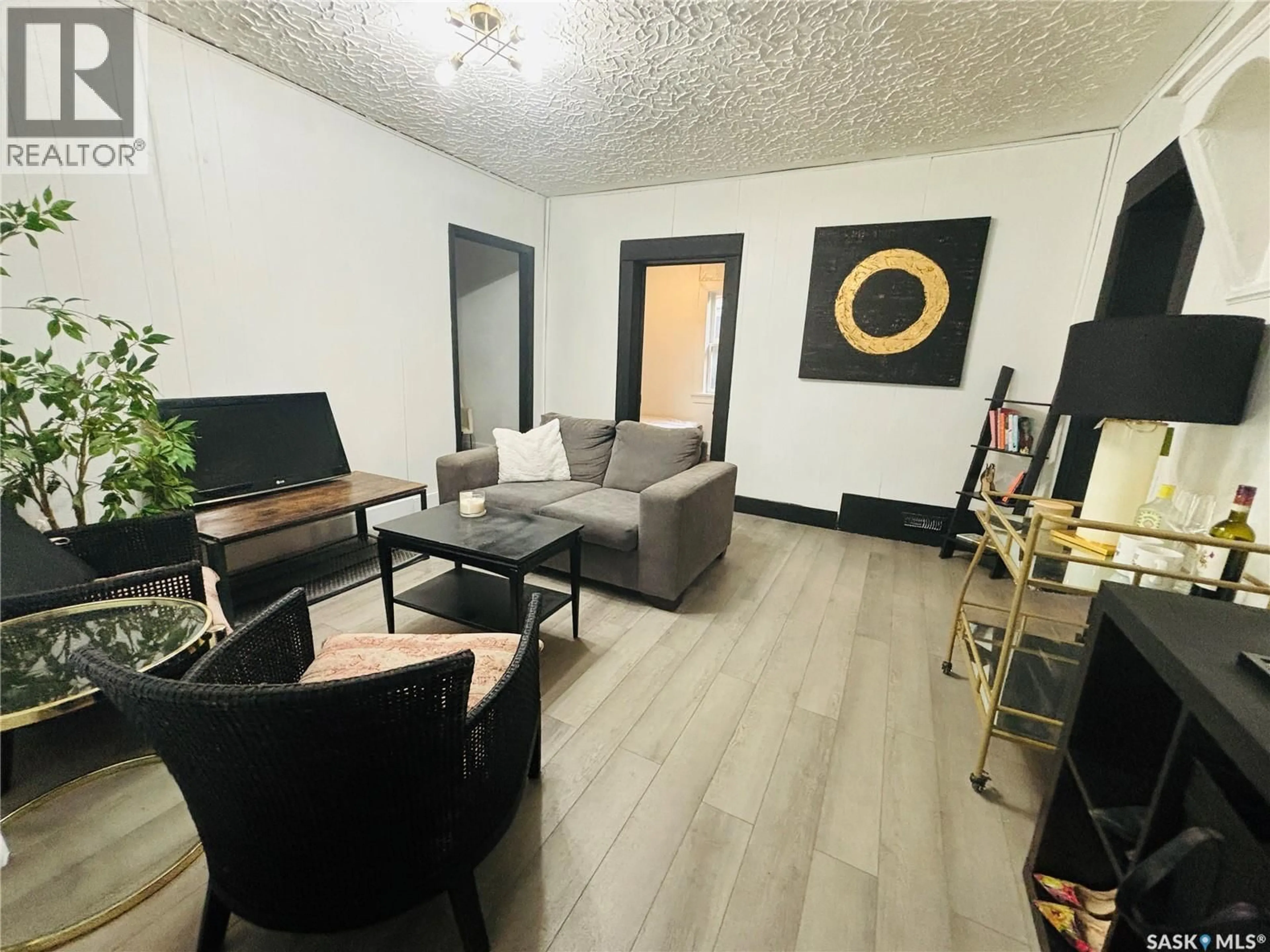 Living room with furniture, wood/laminate floor for 1235 12TH AVENUE, Regina Saskatchewan S4P0L2