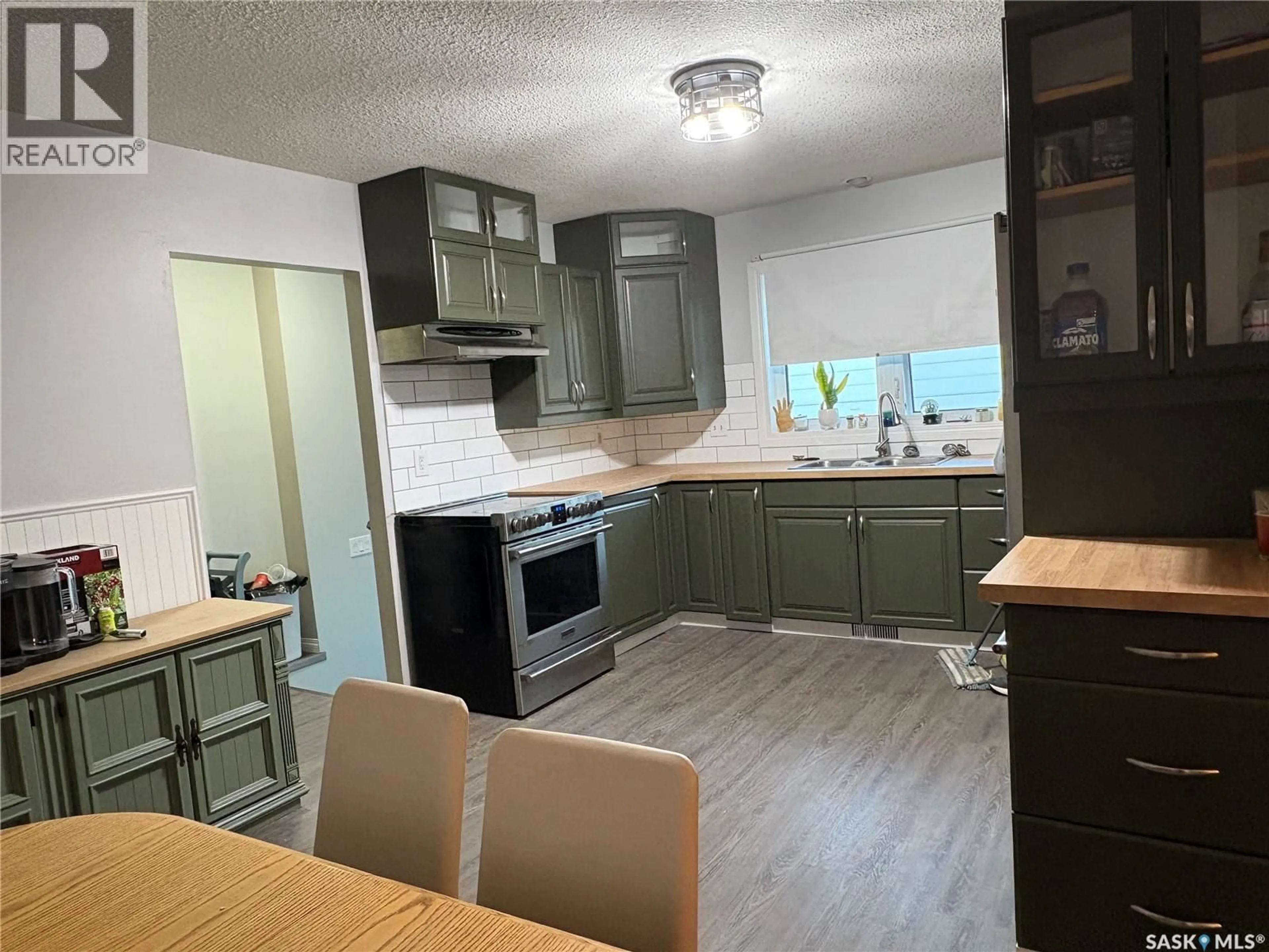 Open concept kitchen, wood/laminate floor for 1181 ASHLEY DRIVE, Swift Current Saskatchewan S9H1N4