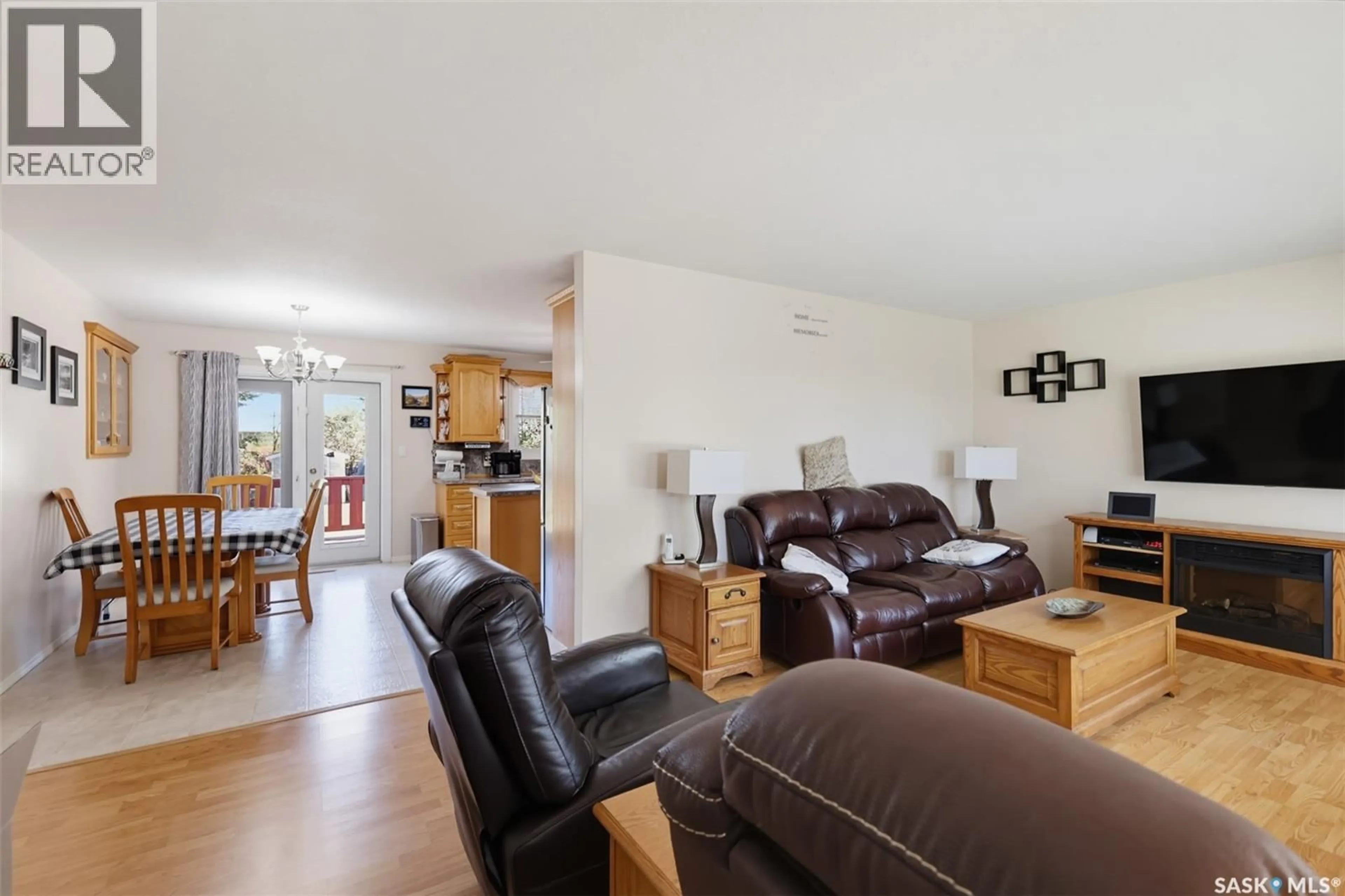 Living room with furniture, wood/laminate floor for 313 4TH AVENUE, Cudworth Saskatchewan S0K1B0