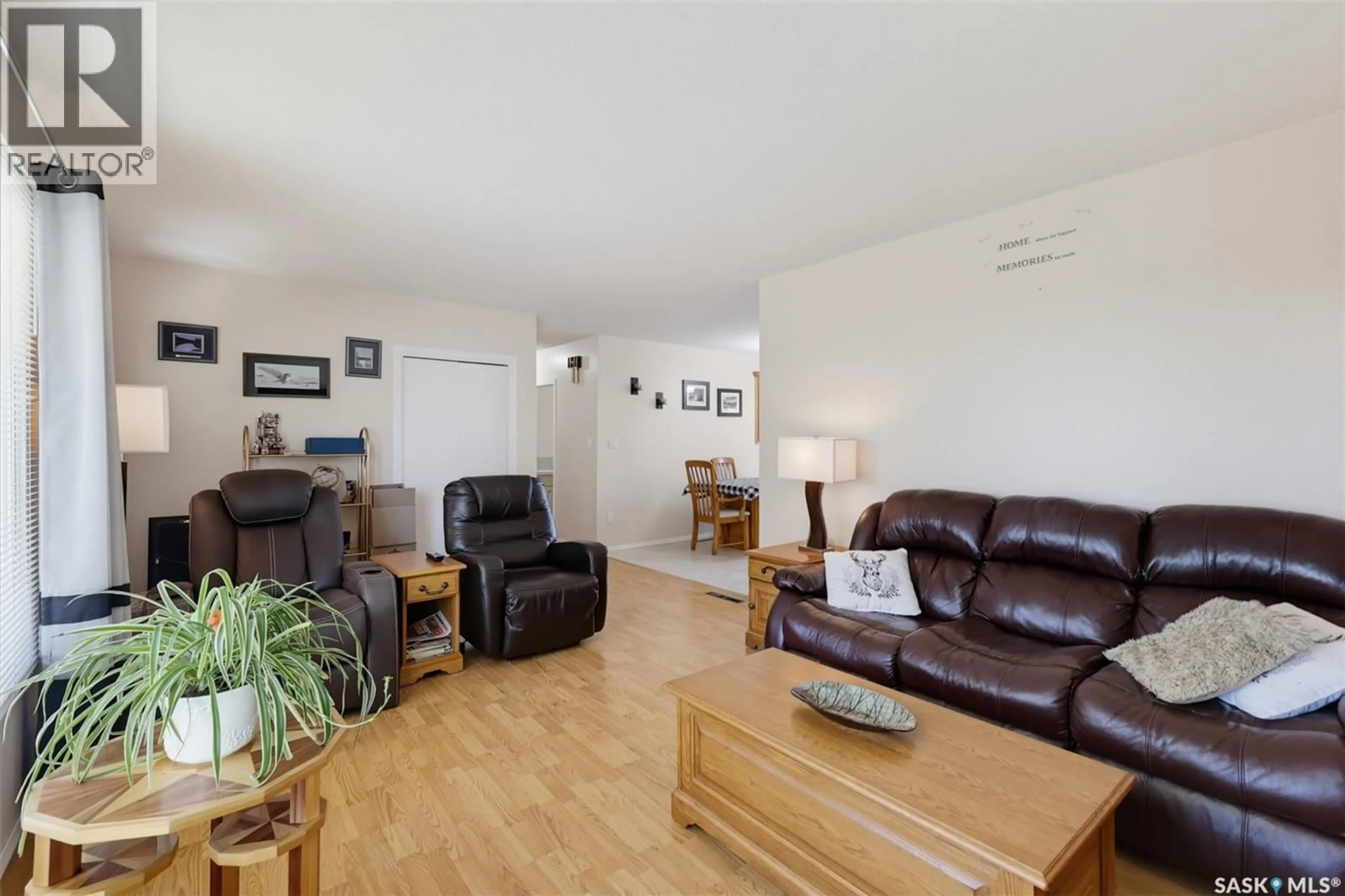 Living room with furniture, wood/laminate floor for 313 4TH AVENUE, Cudworth Saskatchewan S0K1B0