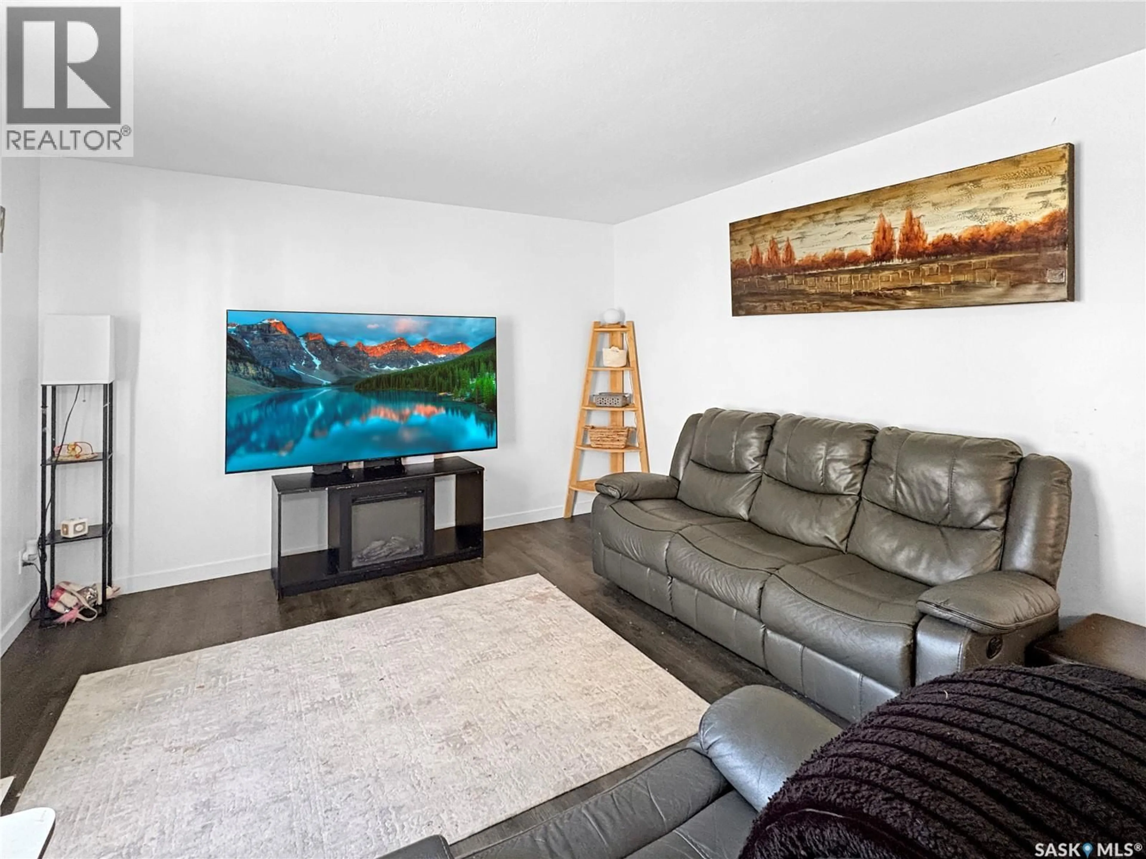 Living room with furniture, wood/laminate floor for 351 26TH STREET, Battleford Saskatchewan S0M0E0