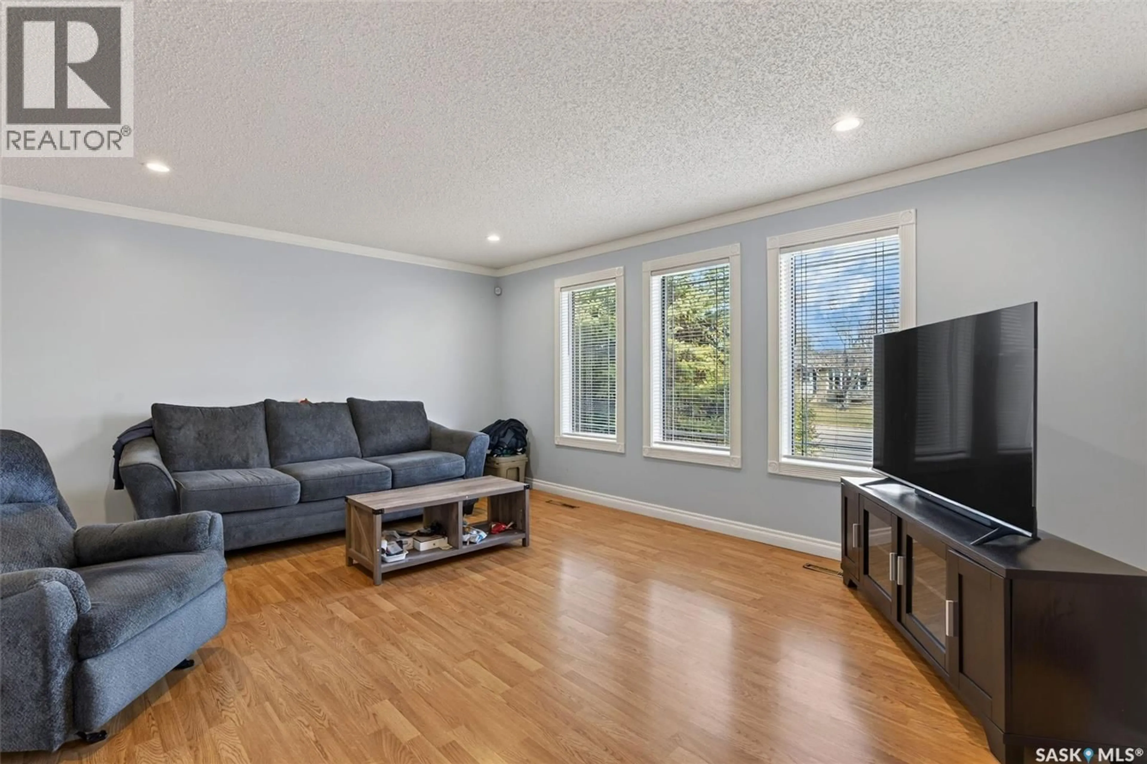 Living room with furniture, wood/laminate floor for 109 PARK AVENUE, Melfort Saskatchewan S0E1A0