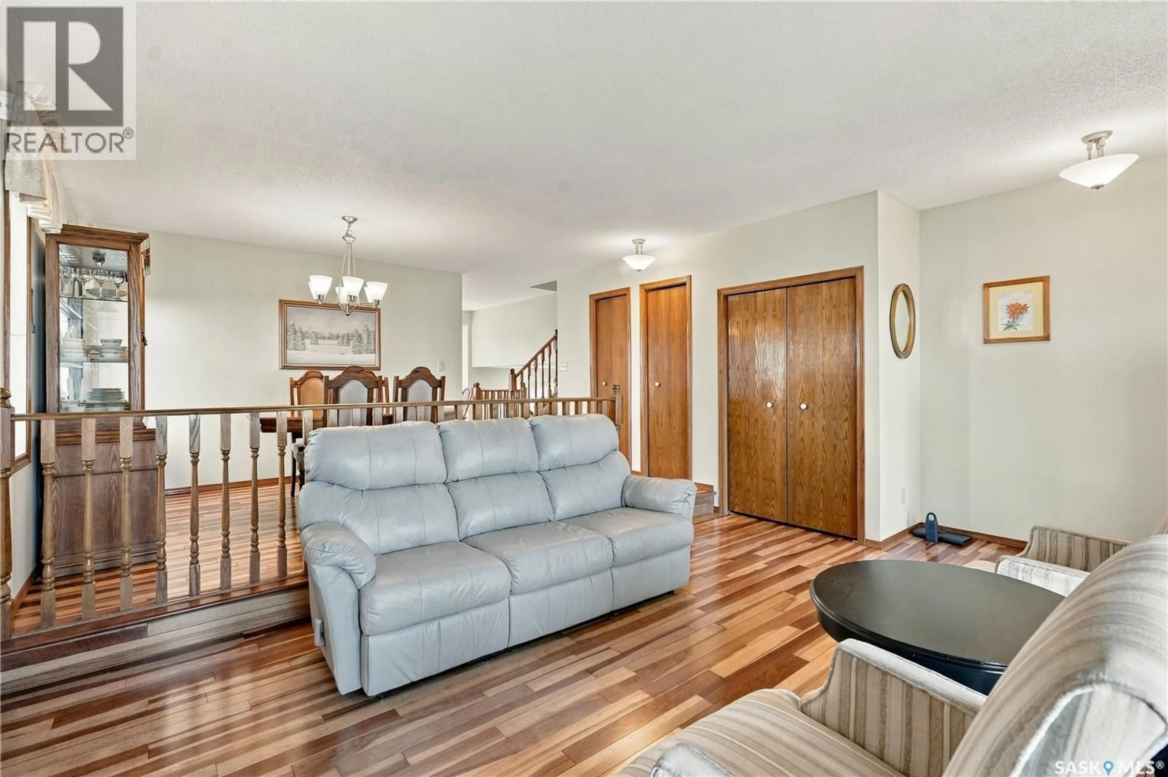 Living room with furniture, wood/laminate floor for 518 BRONSON CRESCENT, Saskatoon Saskatchewan S7J5E3