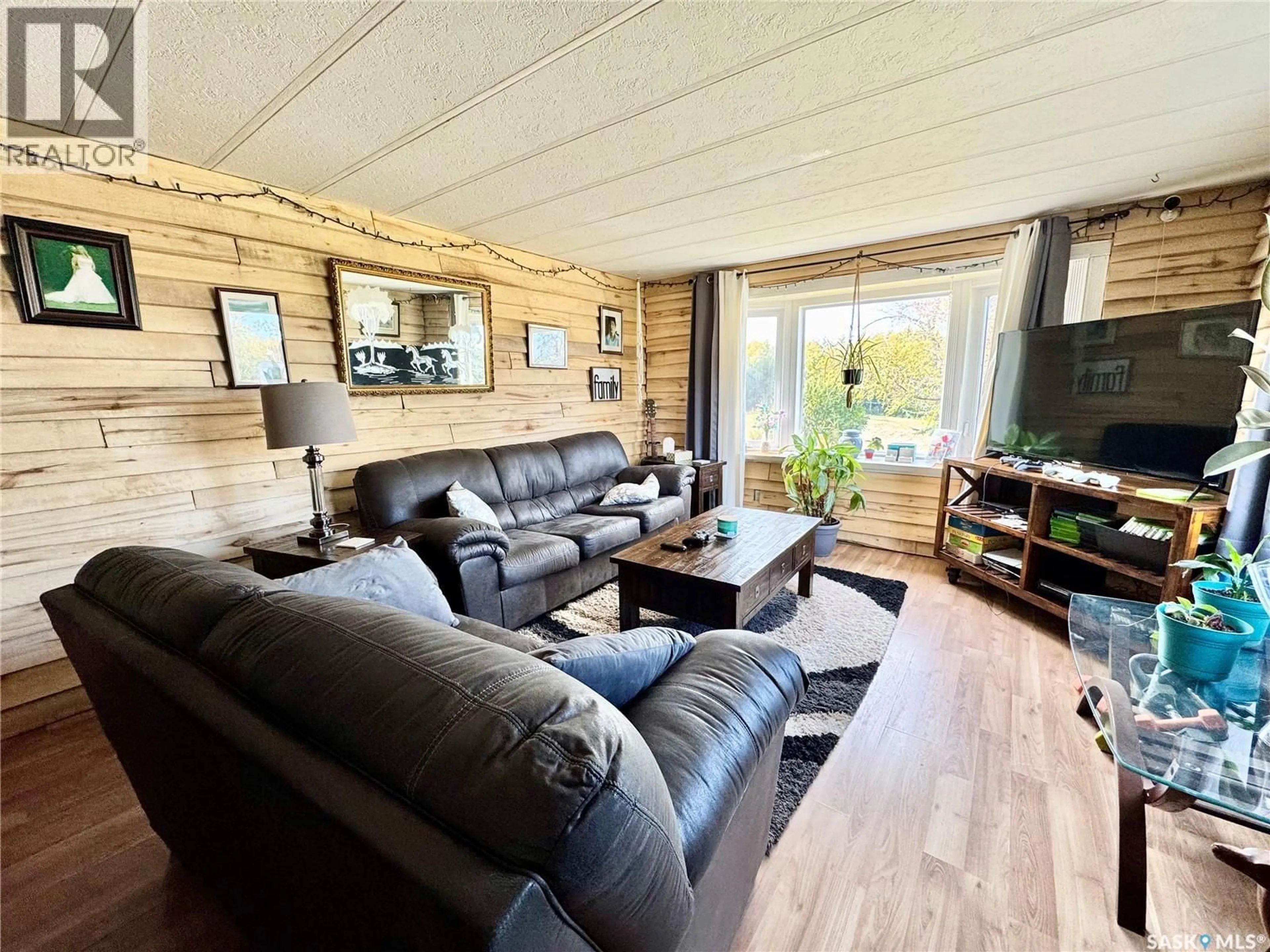 Living room with furniture, wood/laminate floor for 2 HWY 2 SOUTH ACREAGE, Prince Albert Rm No. 461 Saskatchewan S6V5P9