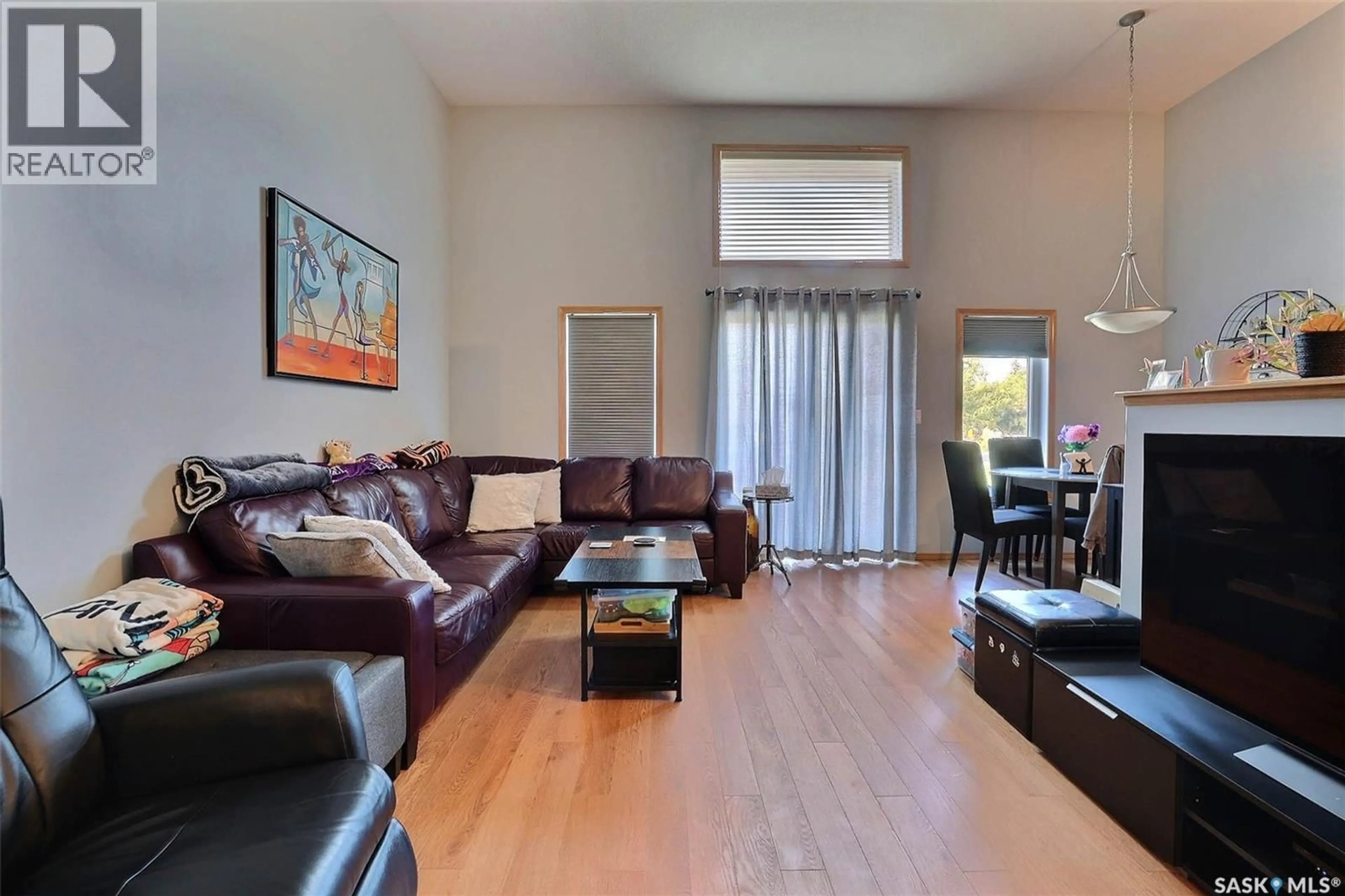 Living room with furniture, wood/laminate floor for 276 MOUNT ROYAL PLACE, Regina Saskatchewan S4T7X9