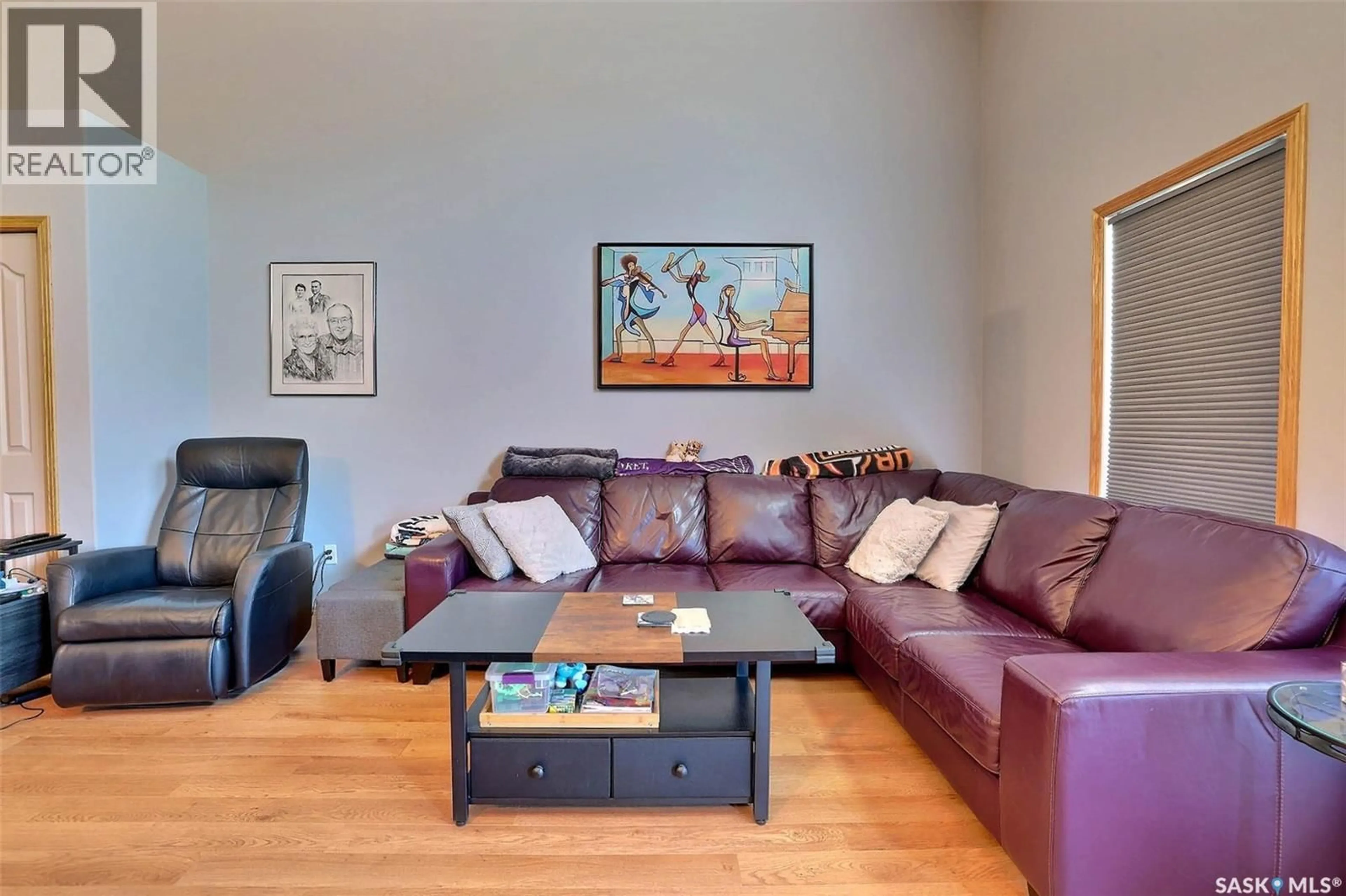 Living room with furniture, wood/laminate floor for 276 MOUNT ROYAL PLACE, Regina Saskatchewan S4T7X9