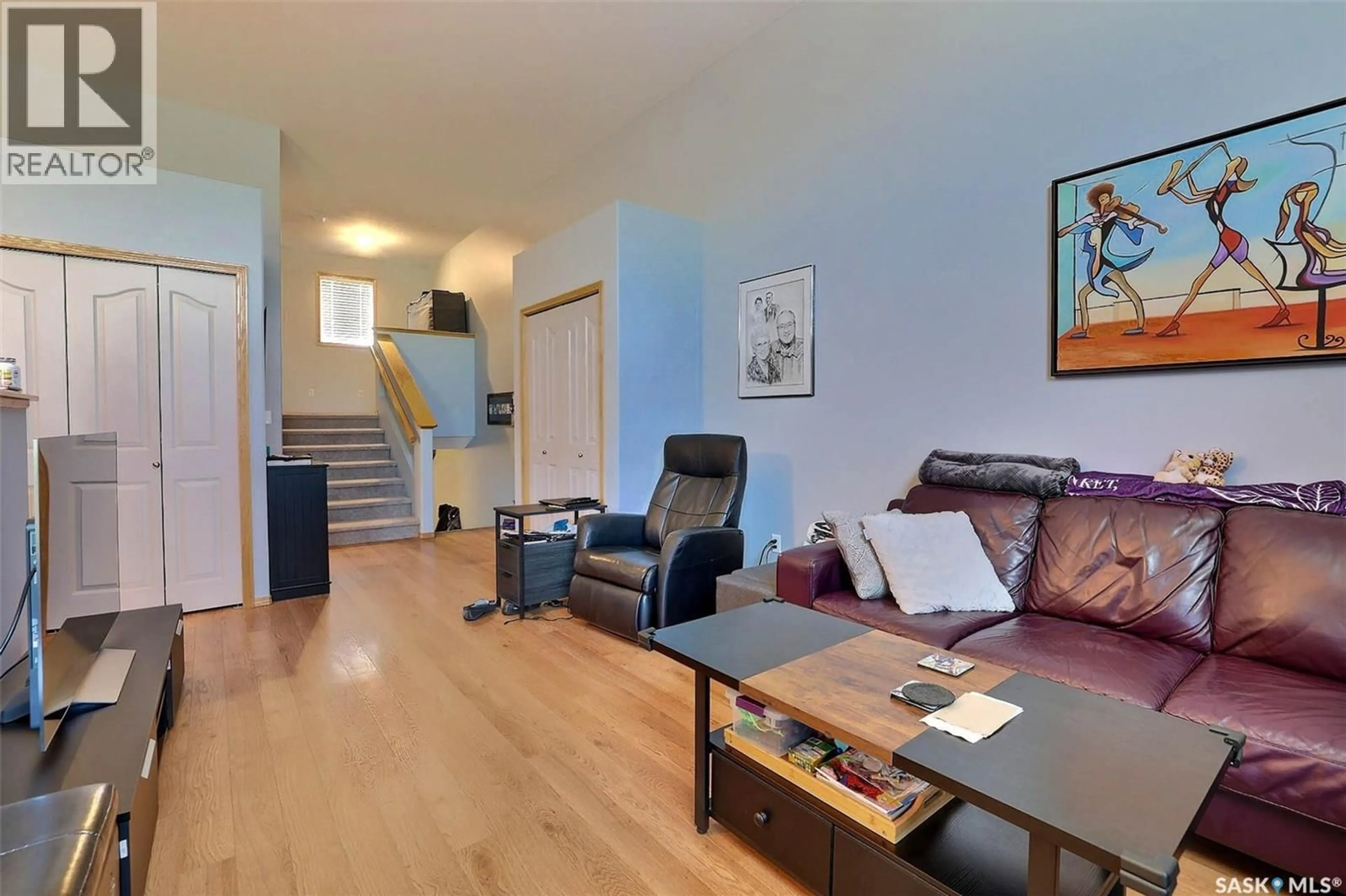Living room with furniture, wood/laminate floor for 276 MOUNT ROYAL PLACE, Regina Saskatchewan S4T7X9