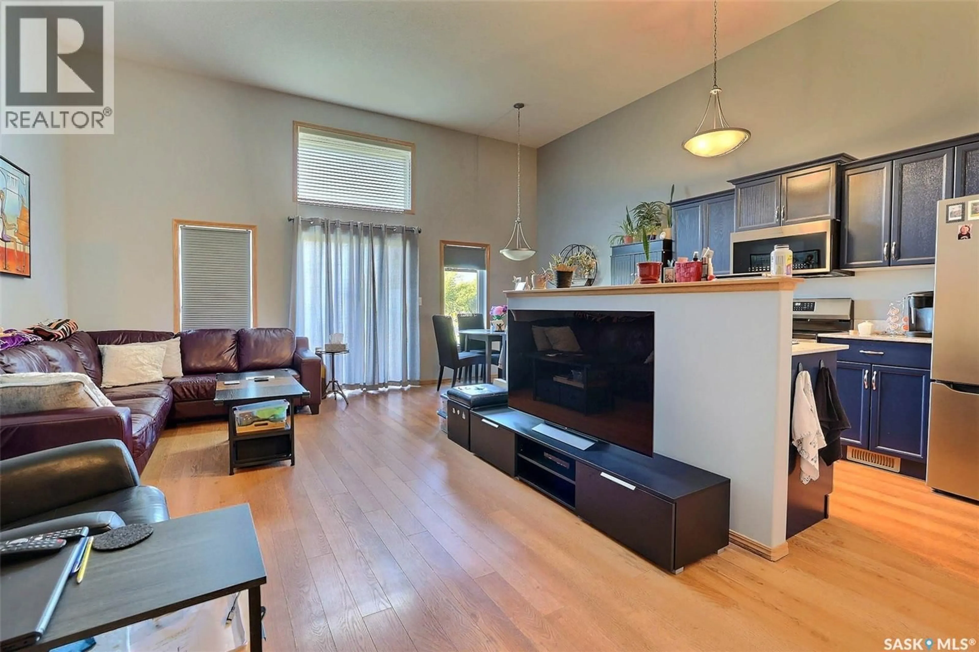 Living room with furniture, wood/laminate floor for 276 MOUNT ROYAL PLACE, Regina Saskatchewan S4T7X9