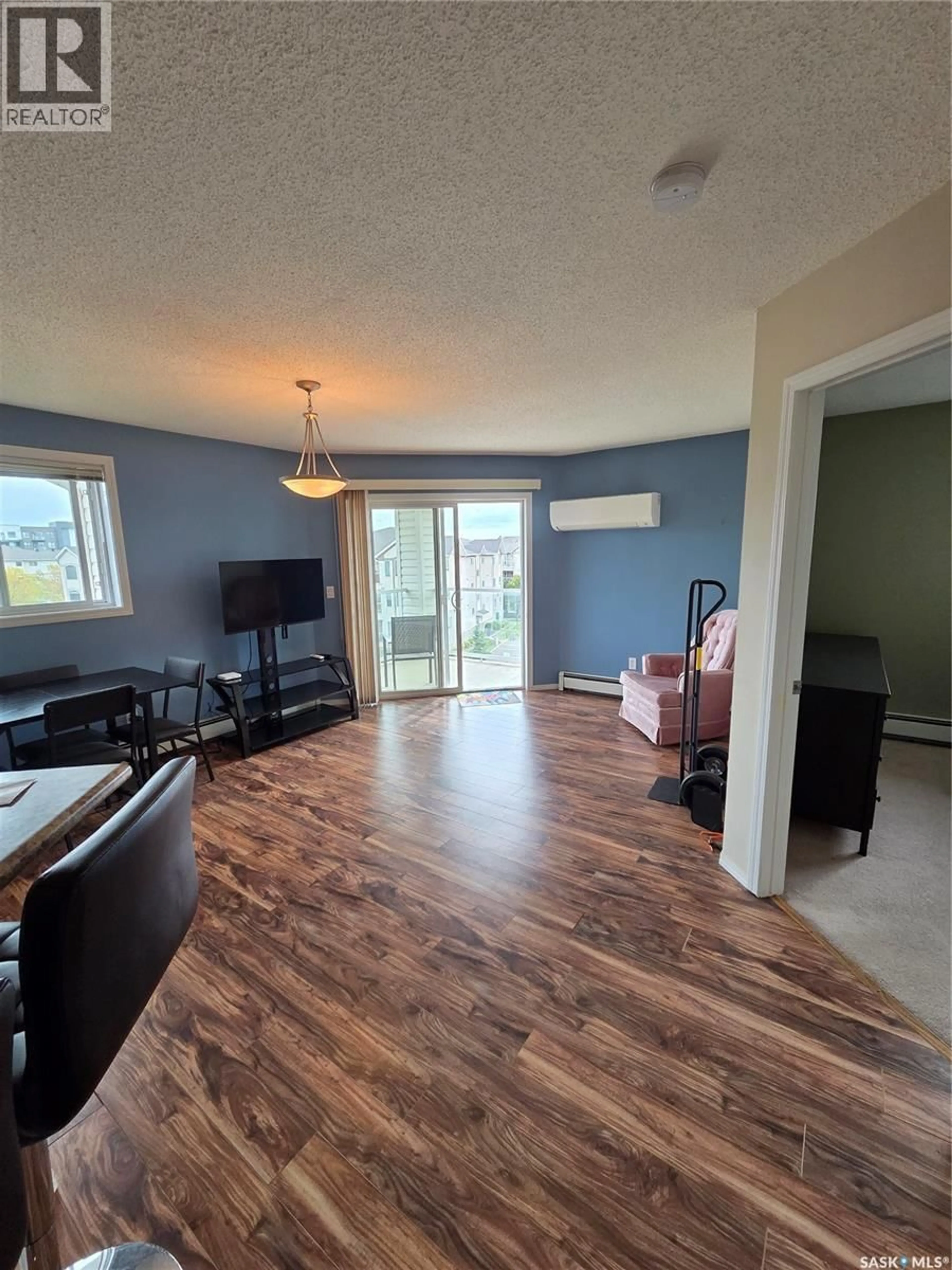 Living room with furniture, wood/laminate floor for 303 - 418 LOWE ROAD, Saskatoon Saskatchewan S7S1P2