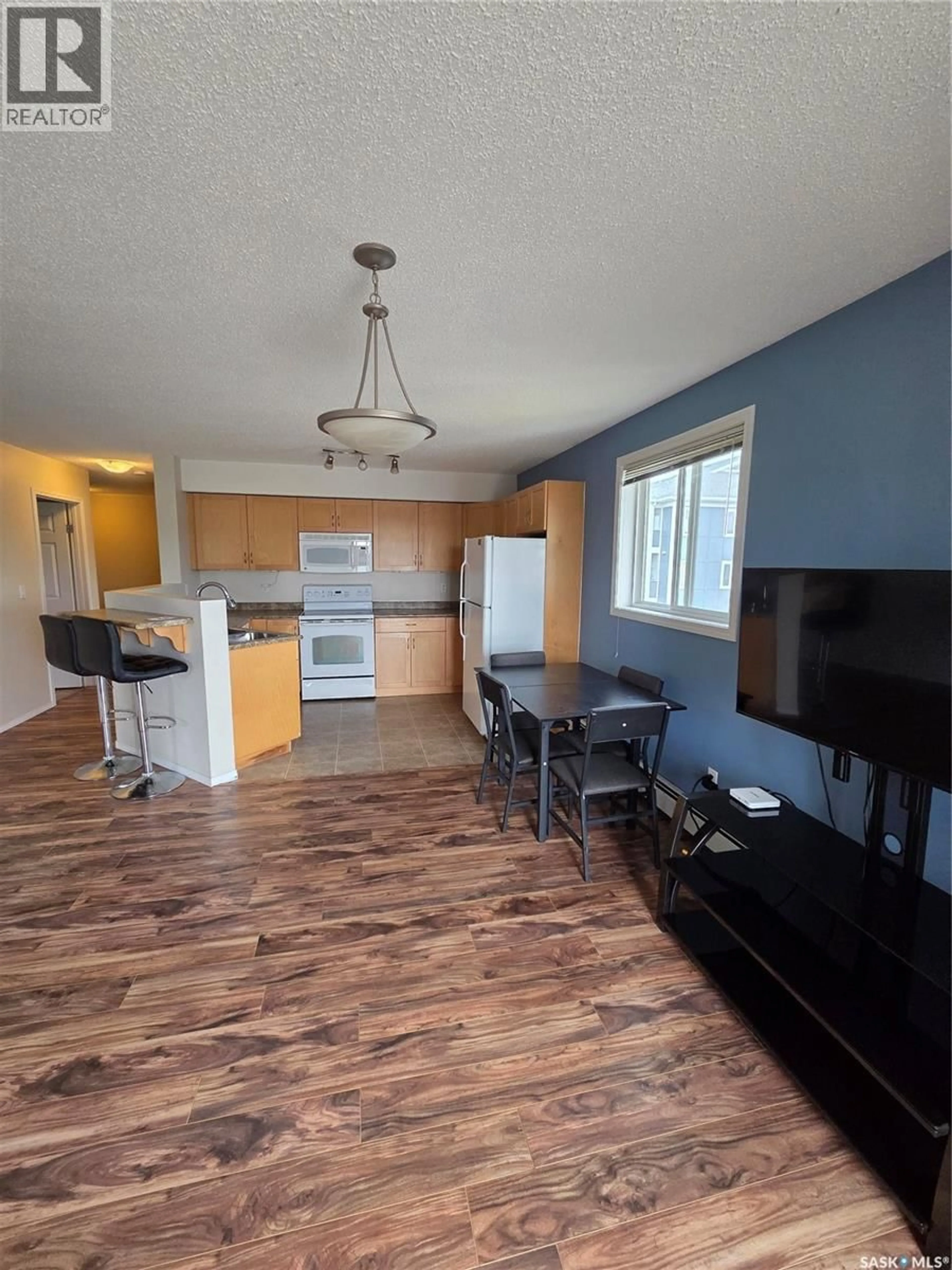 Open concept kitchen, wood/laminate floor for 303 - 418 LOWE ROAD, Saskatoon Saskatchewan S7S1P2