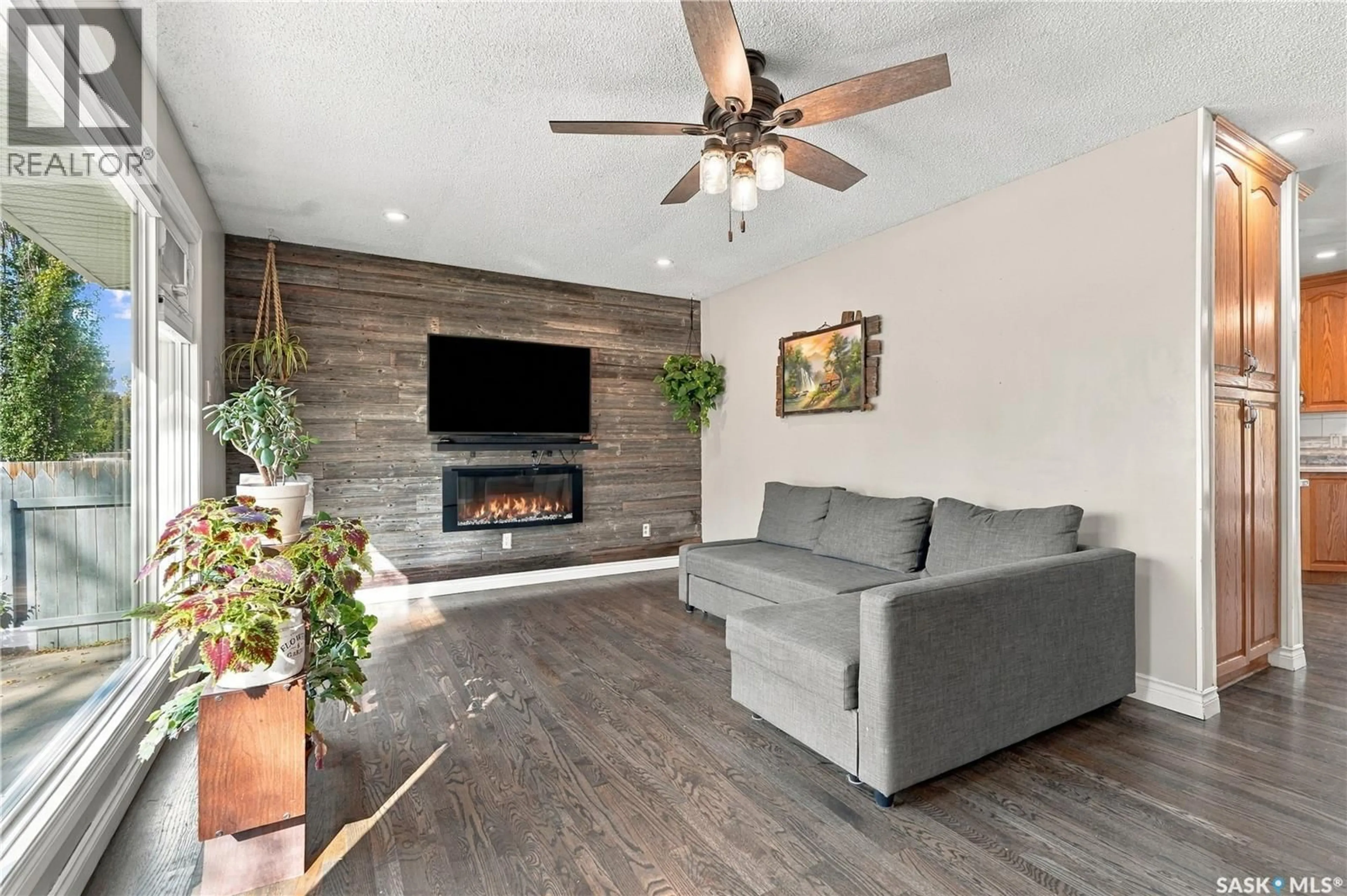 Living room with furniture, wood/laminate floor for 158 SMALLWOOD CRESCENT, Saskatoon Saskatchewan S7L4Z6