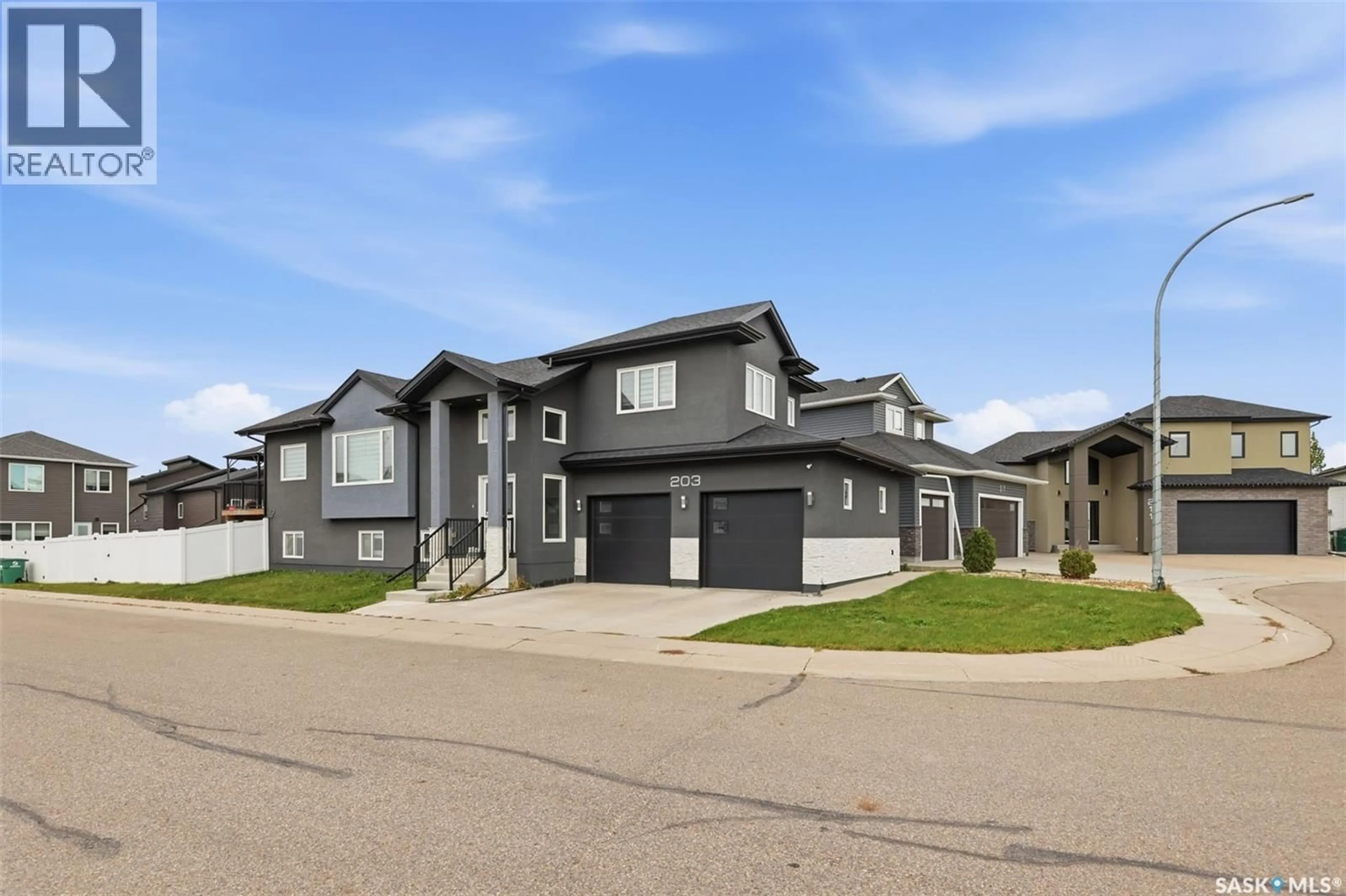 Home with vinyl exterior material, street for 203 BURGESS BAY, Saskatoon Saskatchewan S7V0S3