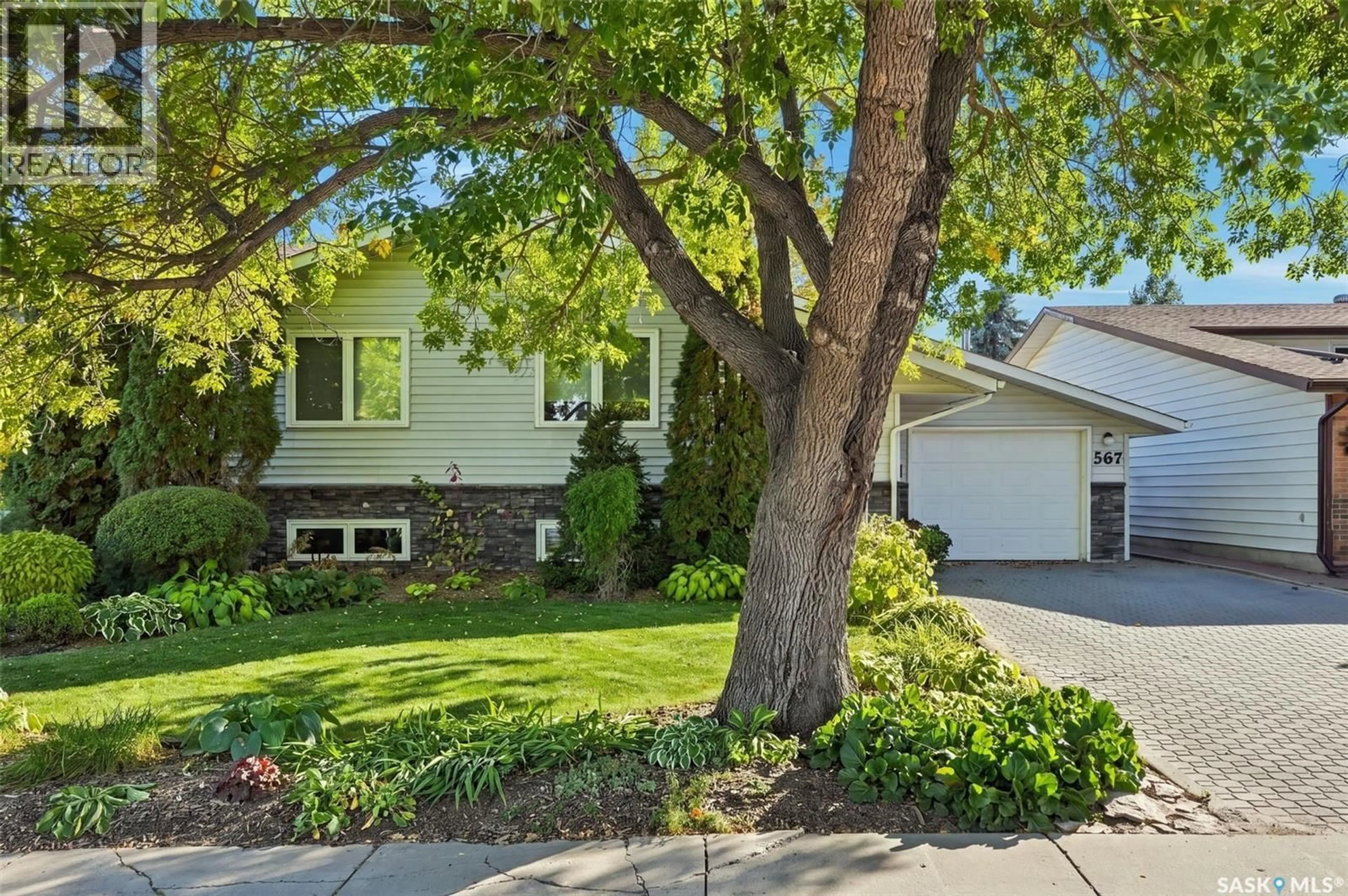 Home with vinyl exterior material, street for 567 ADILMAN DRIVE, Saskatoon Saskatchewan S7K6E8
