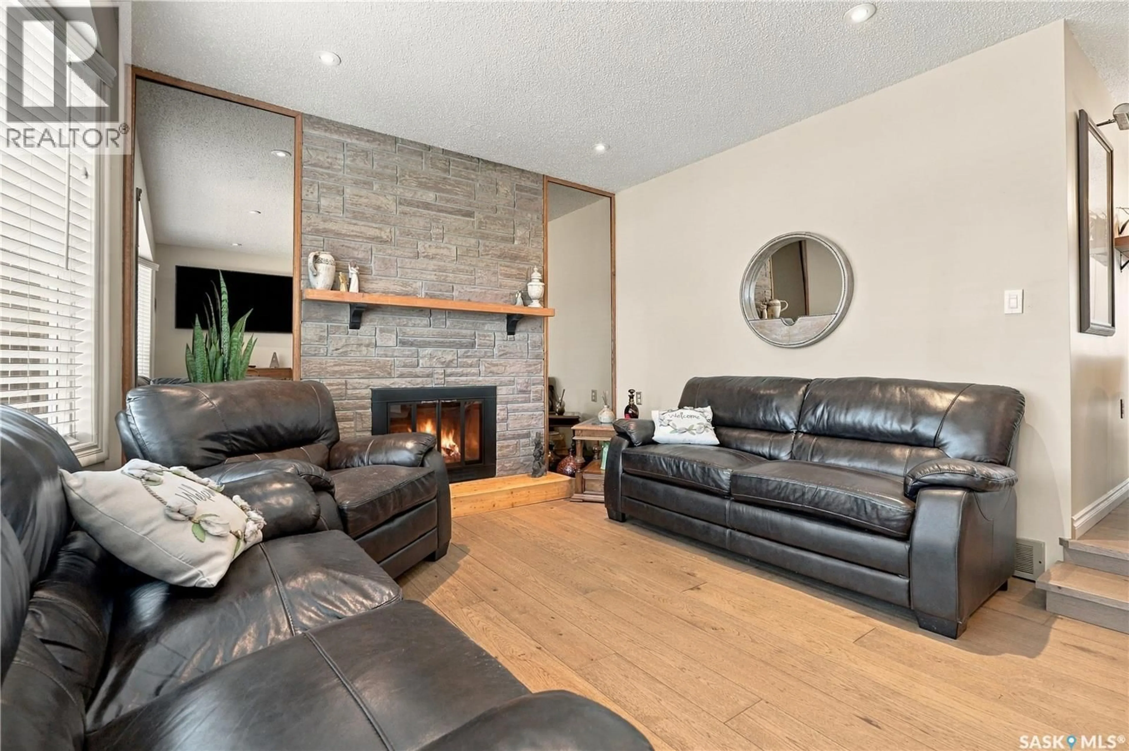 Living room with furniture, wood/laminate floor for 222 SMITH ROAD, Saskatoon Saskatchewan S7M4Z5