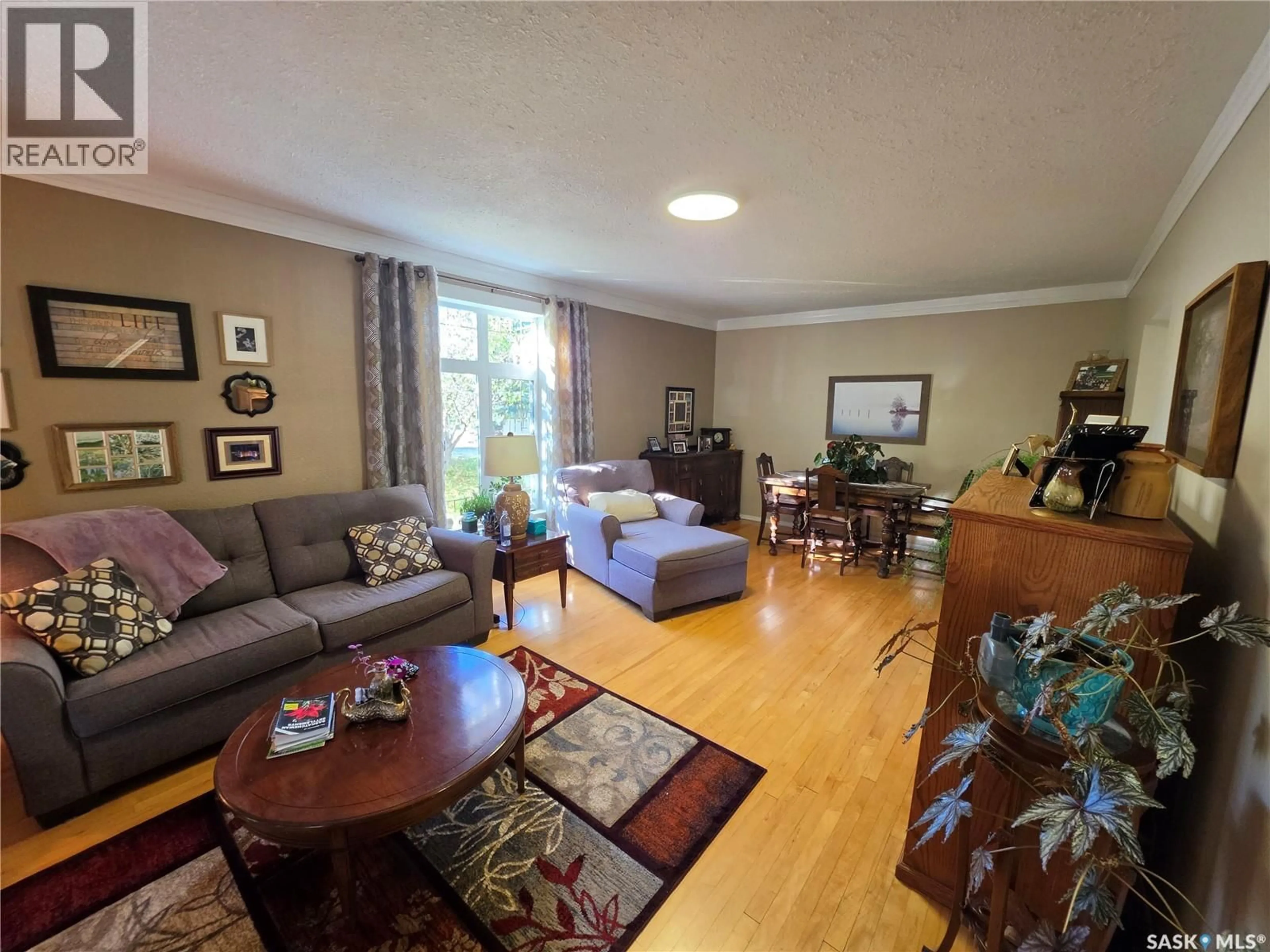 Living room with furniture, wood/laminate floor for 409 3RD AVENUE, Meadow Lake Saskatchewan S9X1B8