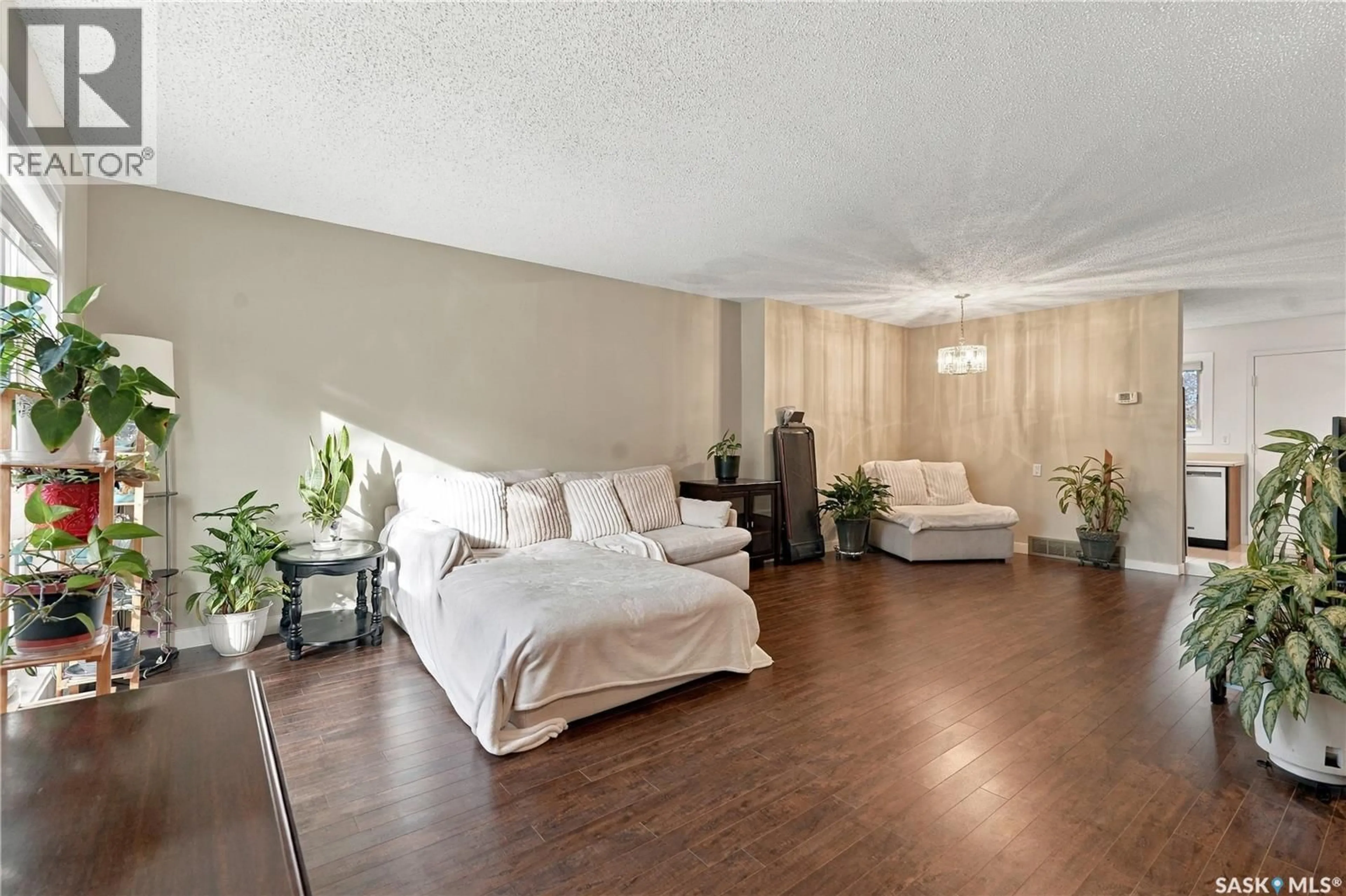 Living room with furniture, wood/laminate floor for 15 PINEHOUSE DRIVE, Saskatoon Saskatchewan S7K5K2