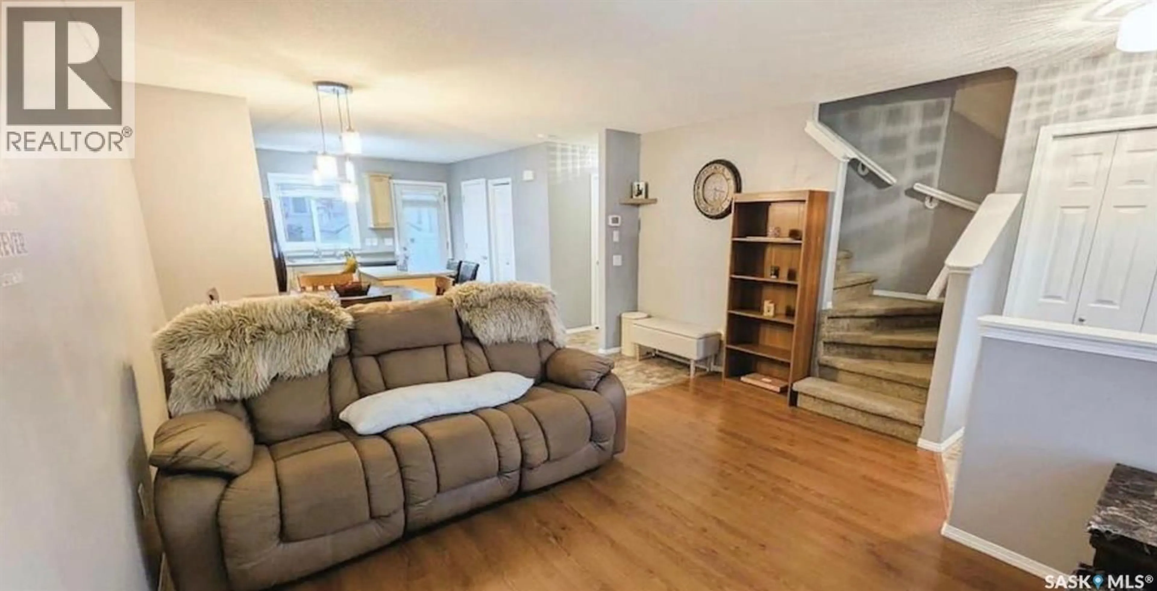 Living room with furniture, wood/laminate floor for 53 2751 WINDSOR PARK ROAD, Regina Saskatchewan S4V1H1