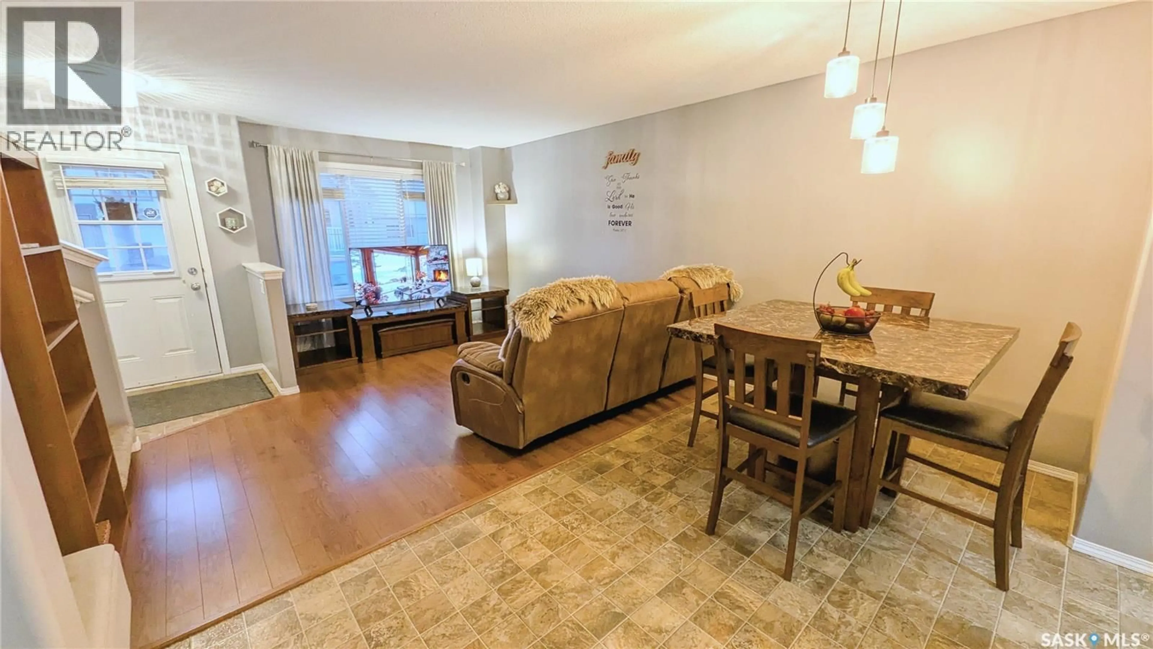 Living room with furniture, wood/laminate floor for 53 2751 WINDSOR PARK ROAD, Regina Saskatchewan S4V1H1