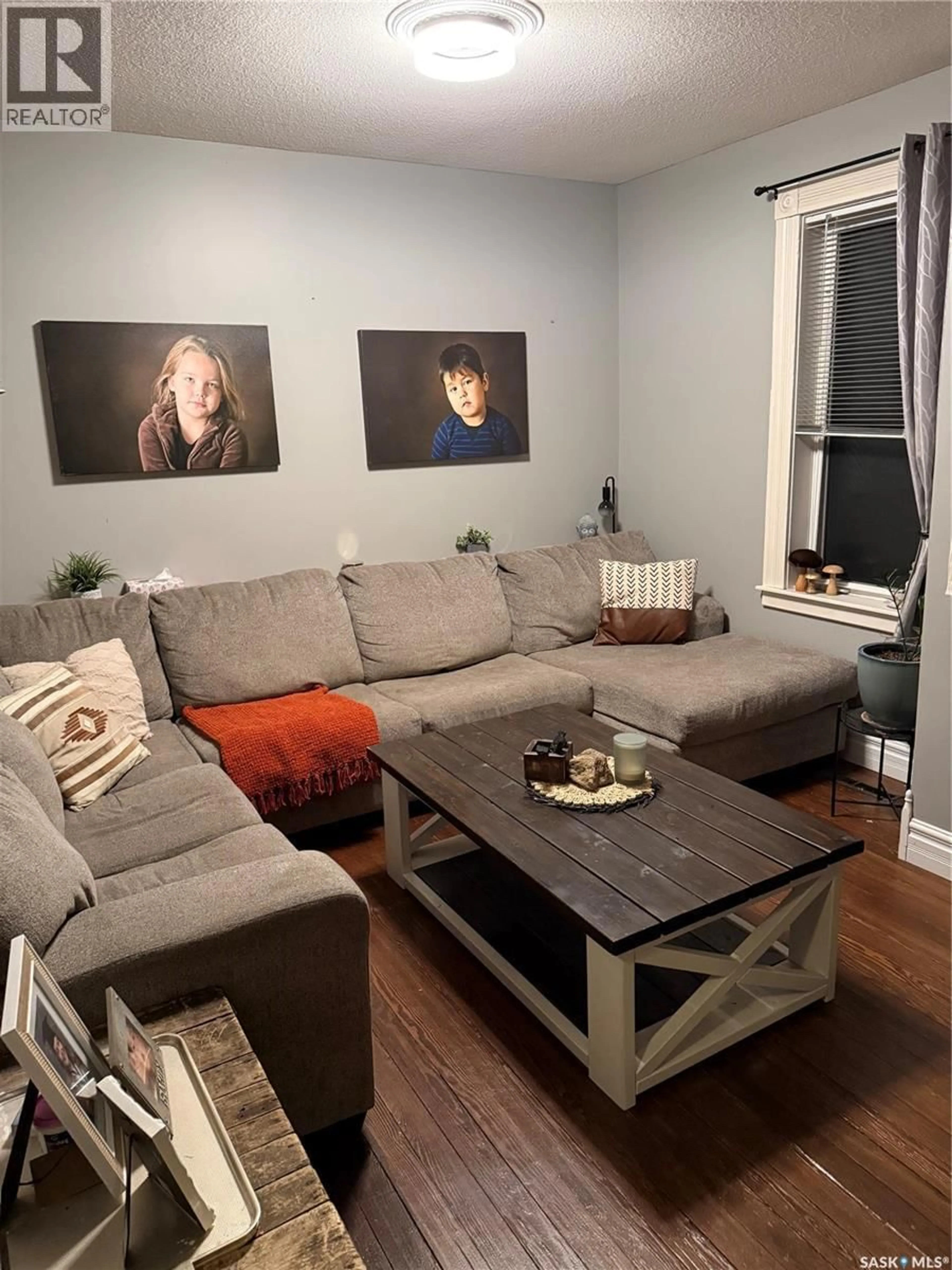 Living room with furniture, wood/laminate floor for 323 3RD AVENUE, Wapella Saskatchewan S0G4Z0