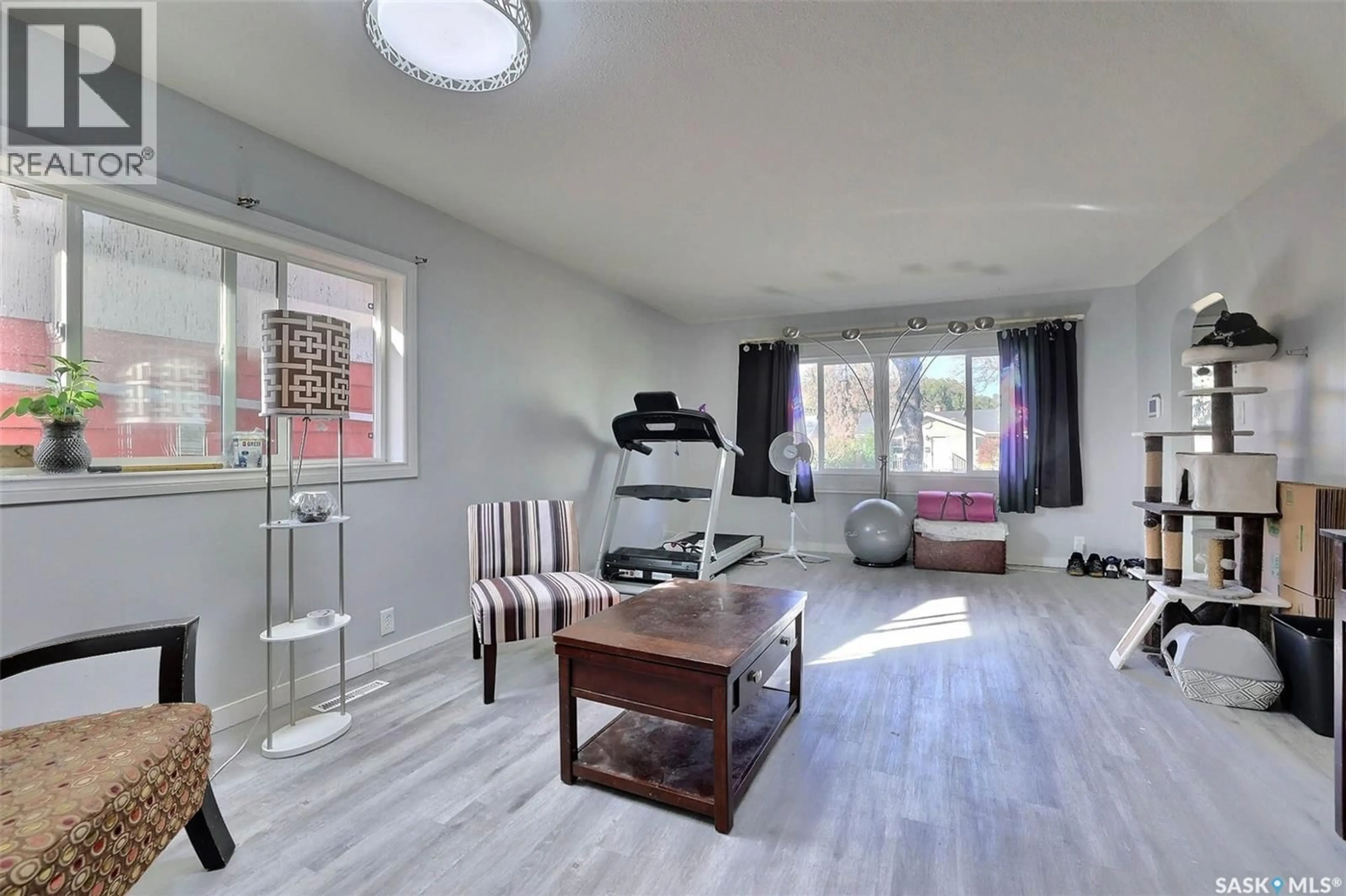 Living room with furniture, wood/laminate floor for 1021 CAMPBELL STREET, Regina Saskatchewan S4T5P5
