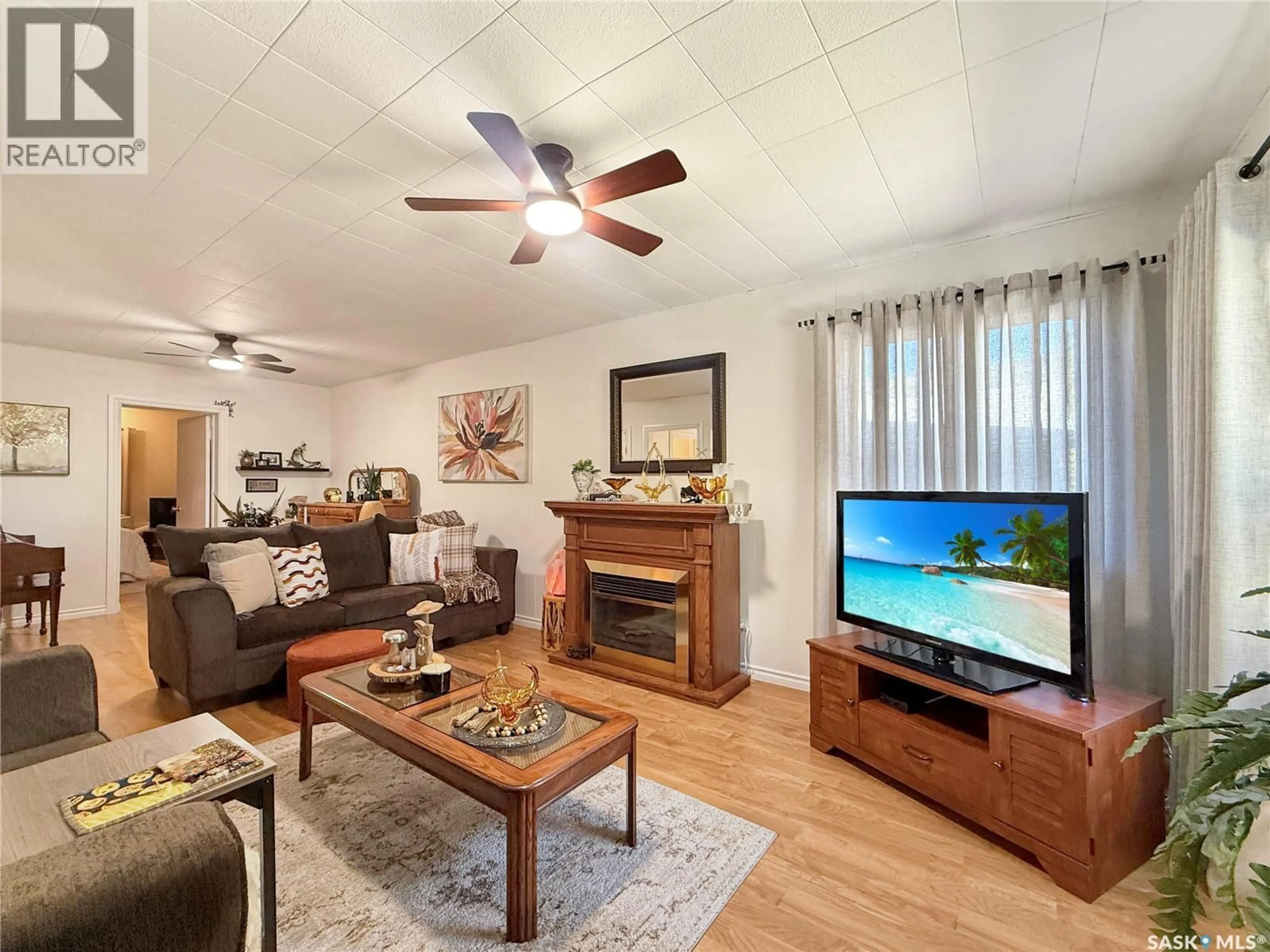 Living room with furniture, wood/laminate floor for 1841 102ND STREET, North Battleford Saskatchewan S9A1H4