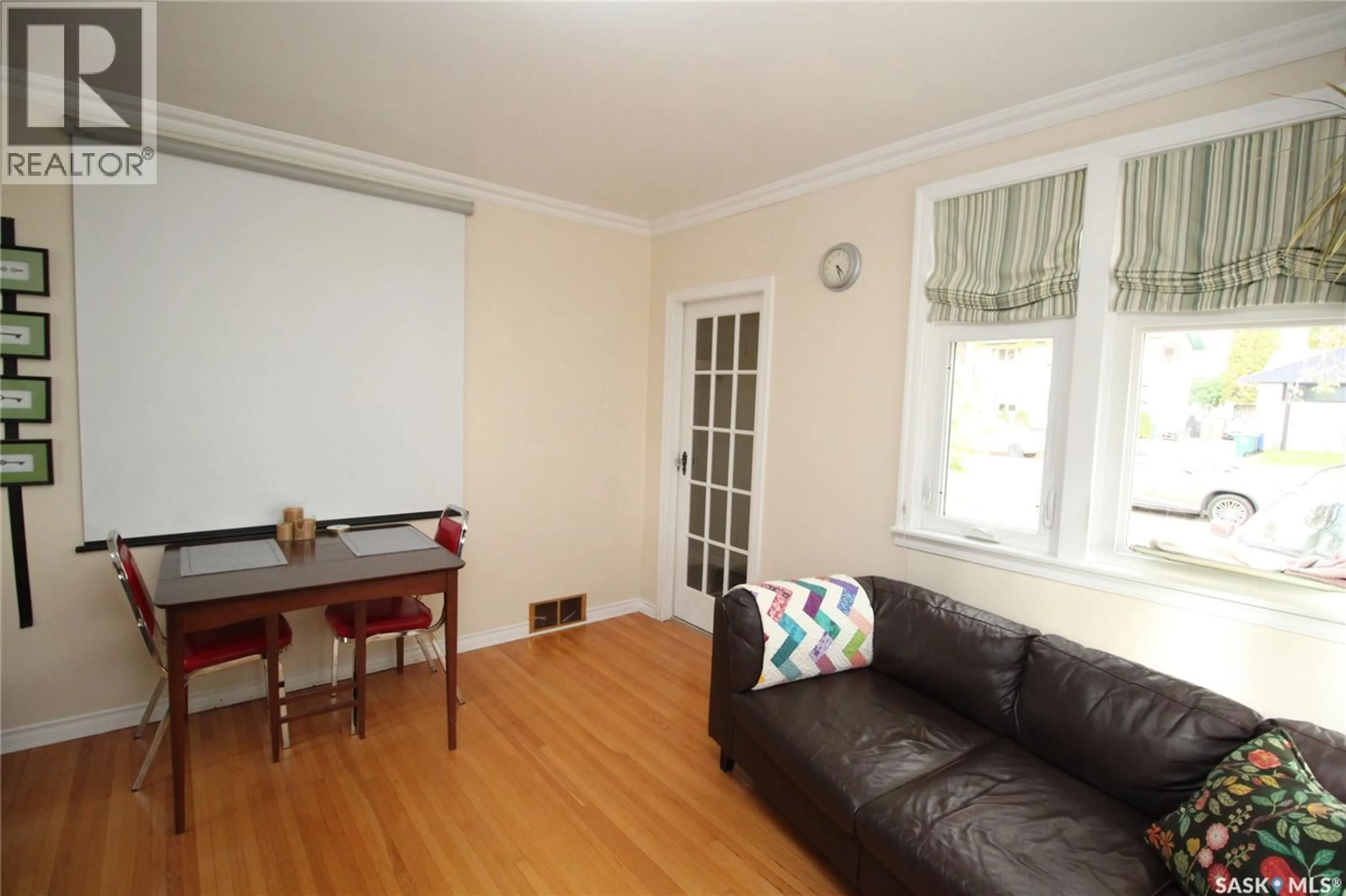 Living room with furniture, wood/laminate floor for 1015 H AVENUE, Saskatoon Saskatchewan S7L2C7
