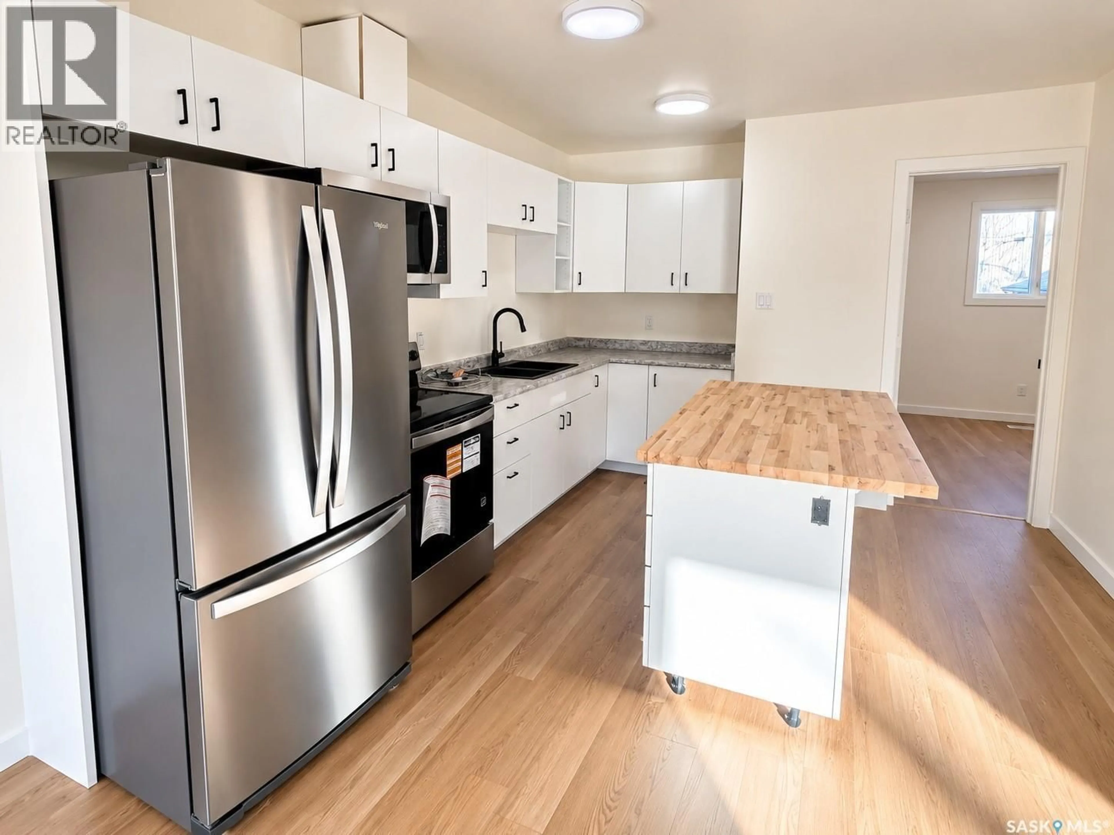Open concept kitchen, wood/laminate floor for 905B ARGYLE AVENUE, Saskatoon Saskatchewan S7H2V9