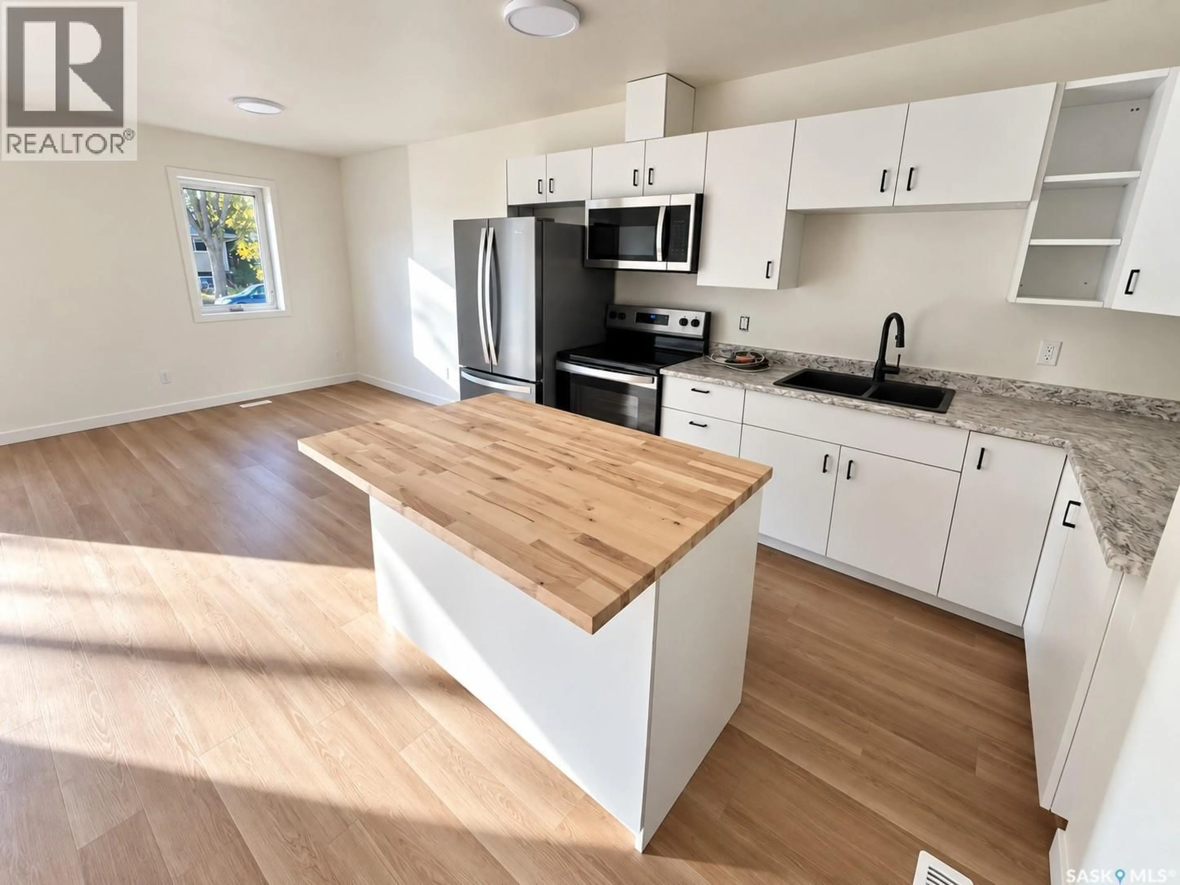 Open concept kitchen, wood/laminate floor for 905B ARGYLE AVENUE, Saskatoon Saskatchewan S7H2V9