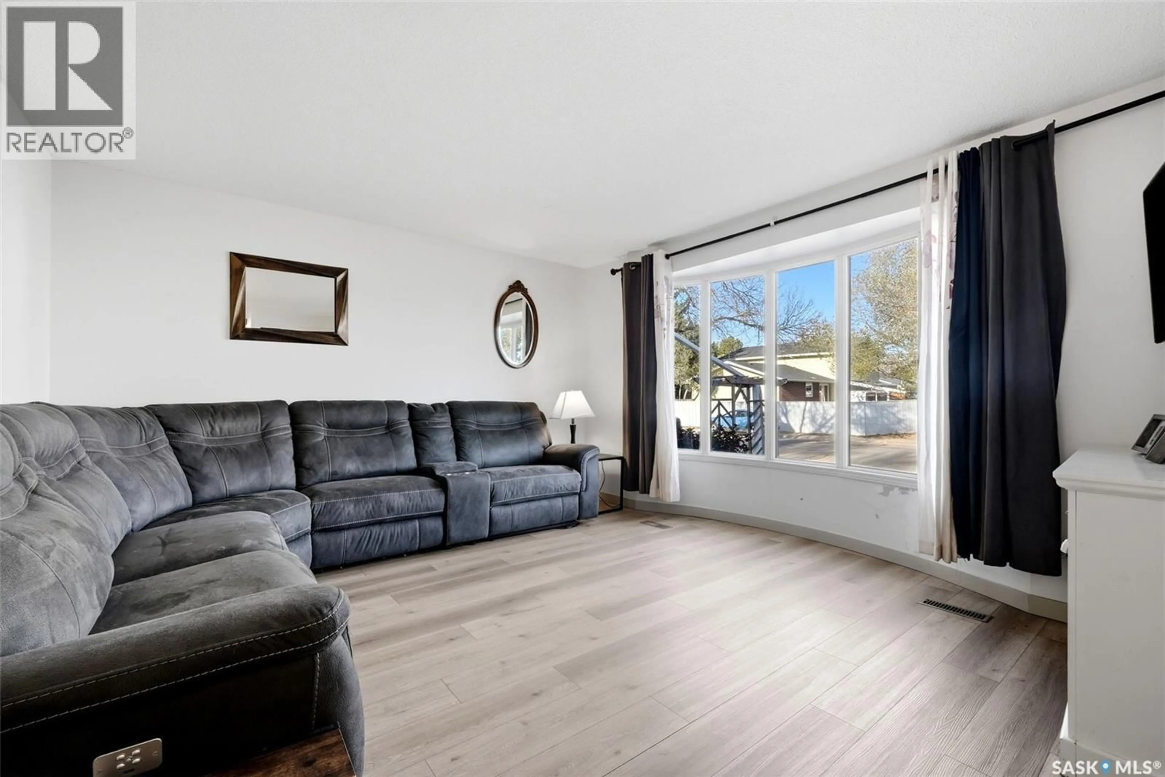 Living room with furniture, wood/laminate floor for 31 BERENSON AVENUE, Regina Saskatchewan S4T6X4