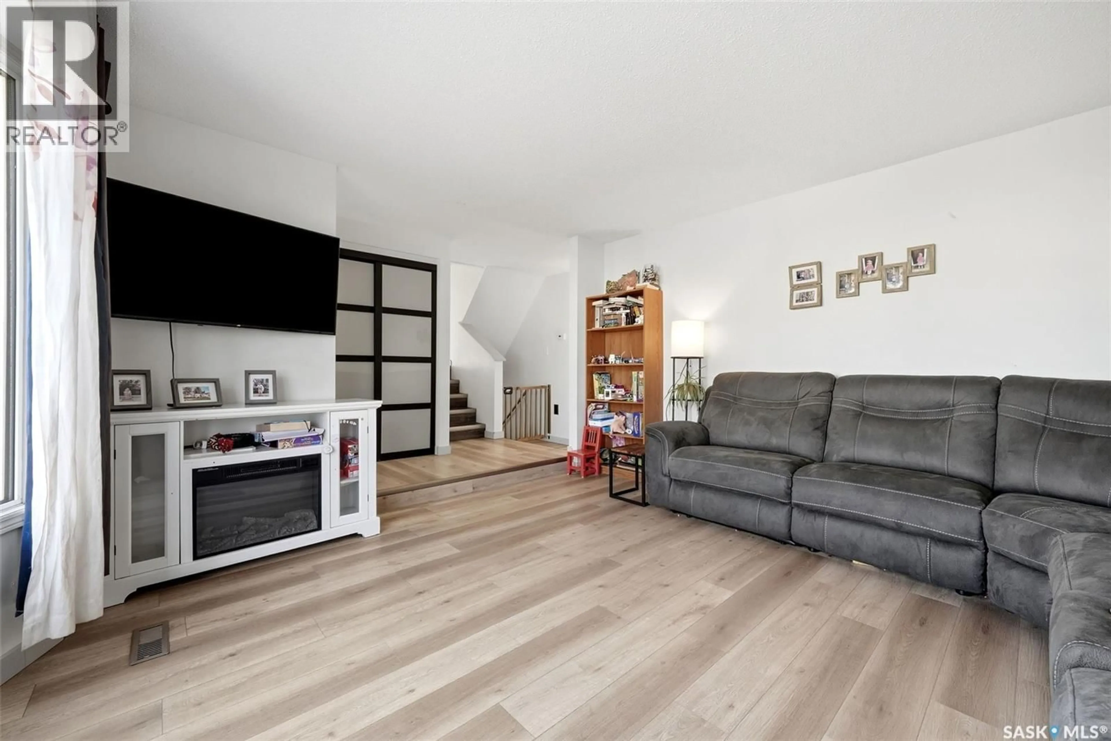 Living room with furniture, wood/laminate floor for 31 BERENSON AVENUE, Regina Saskatchewan S4T6X4