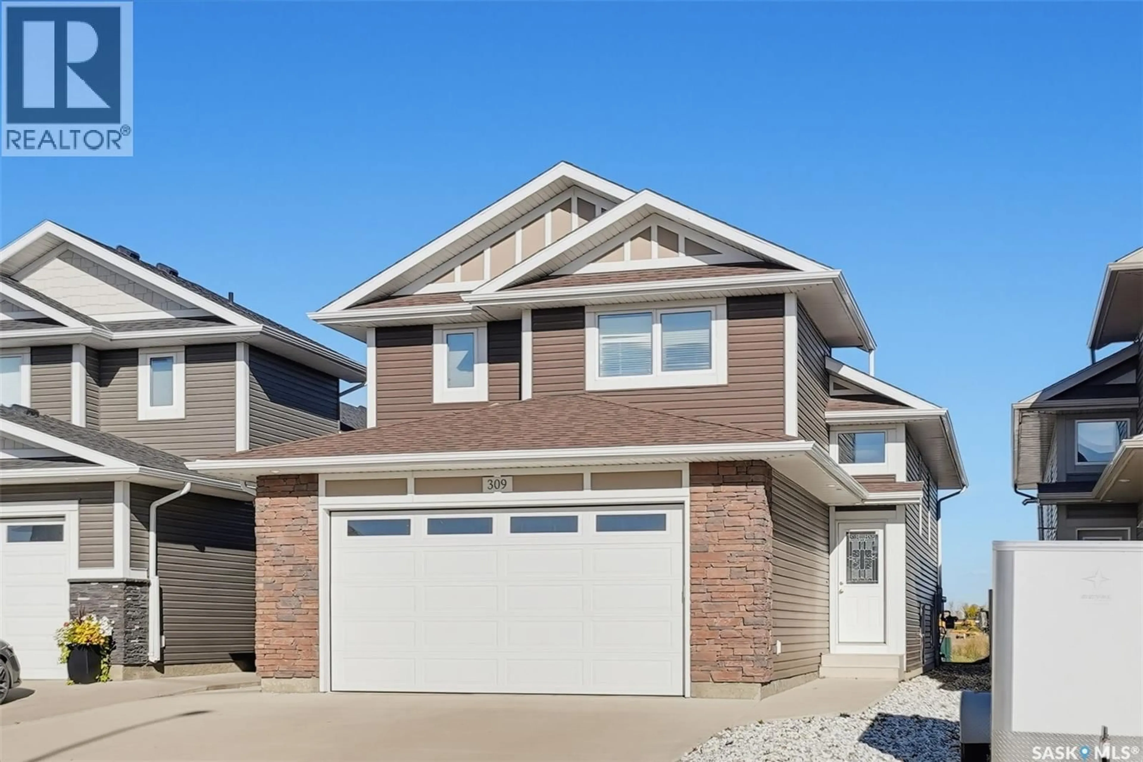 Home with vinyl exterior material, street for 309 BASSETT ROAD, Martensville Saskatchewan S0K2T1