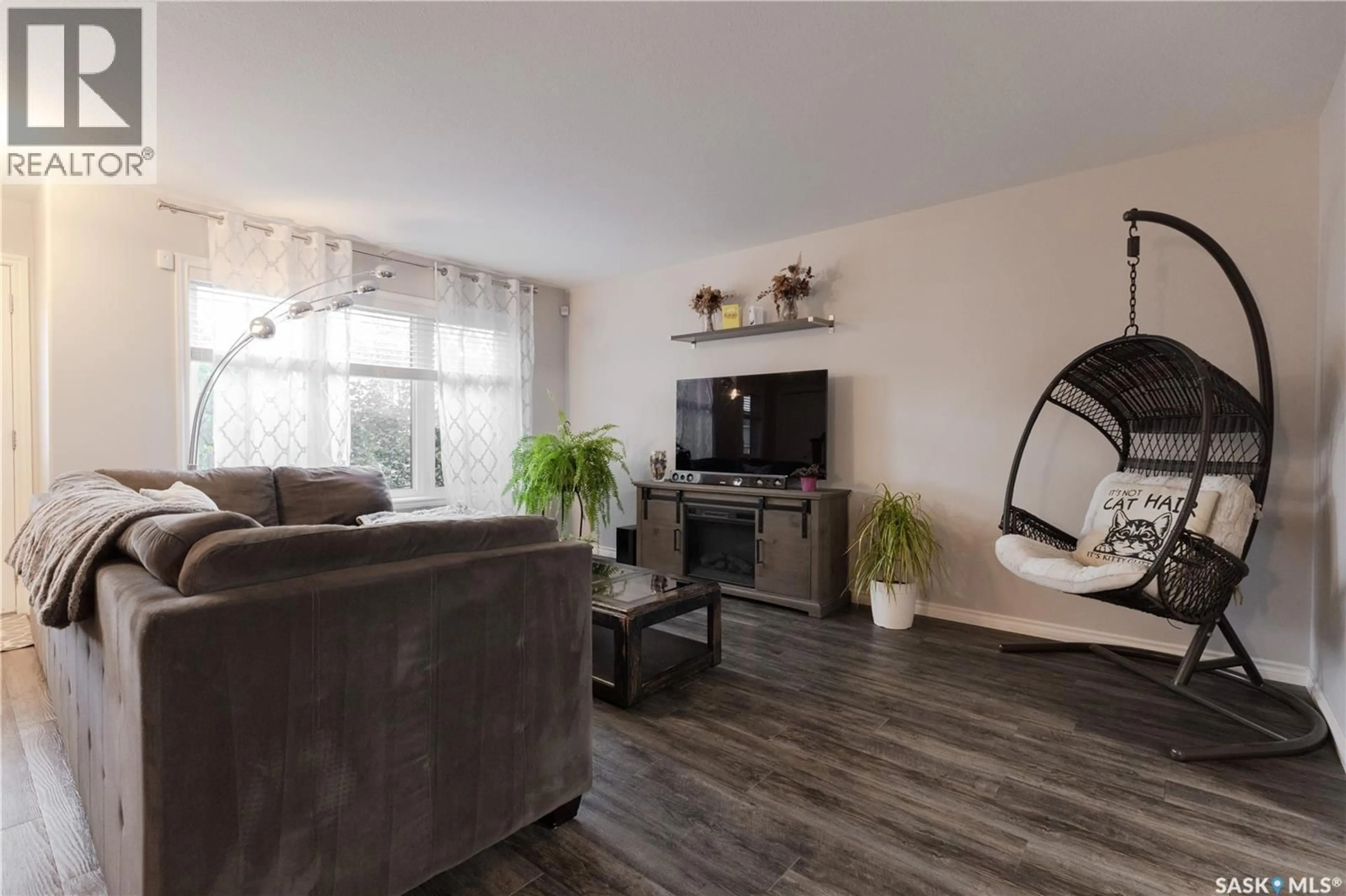 Living room with furniture, wood/laminate floor for 1318 HUNTER ROAD, Saskatoon Saskatchewan S7T0S5