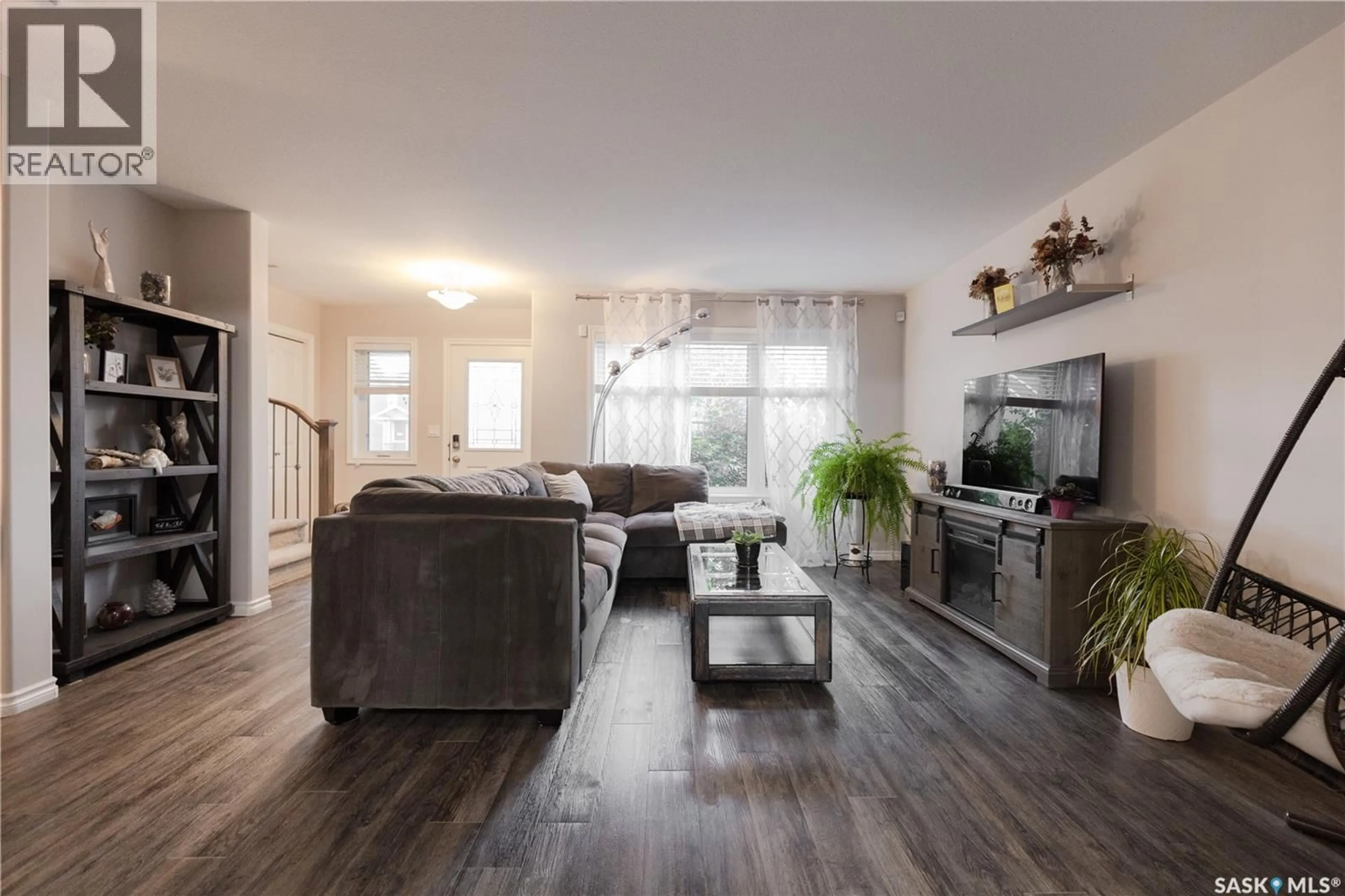 Living room with furniture, wood/laminate floor for 1318 HUNTER ROAD, Saskatoon Saskatchewan S7T0S5