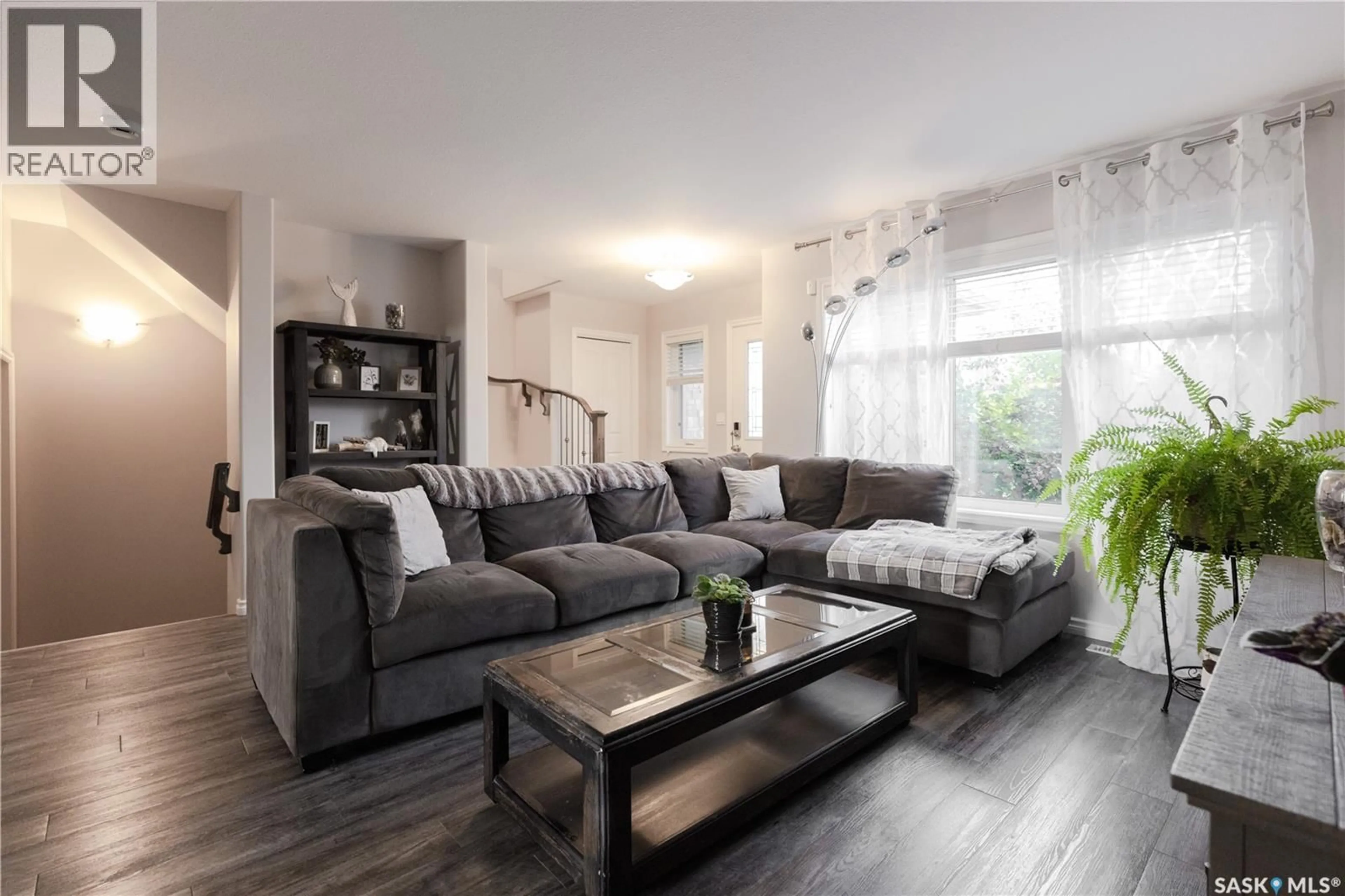 Living room with furniture, wood/laminate floor for 1318 HUNTER ROAD, Saskatoon Saskatchewan S7T0S5