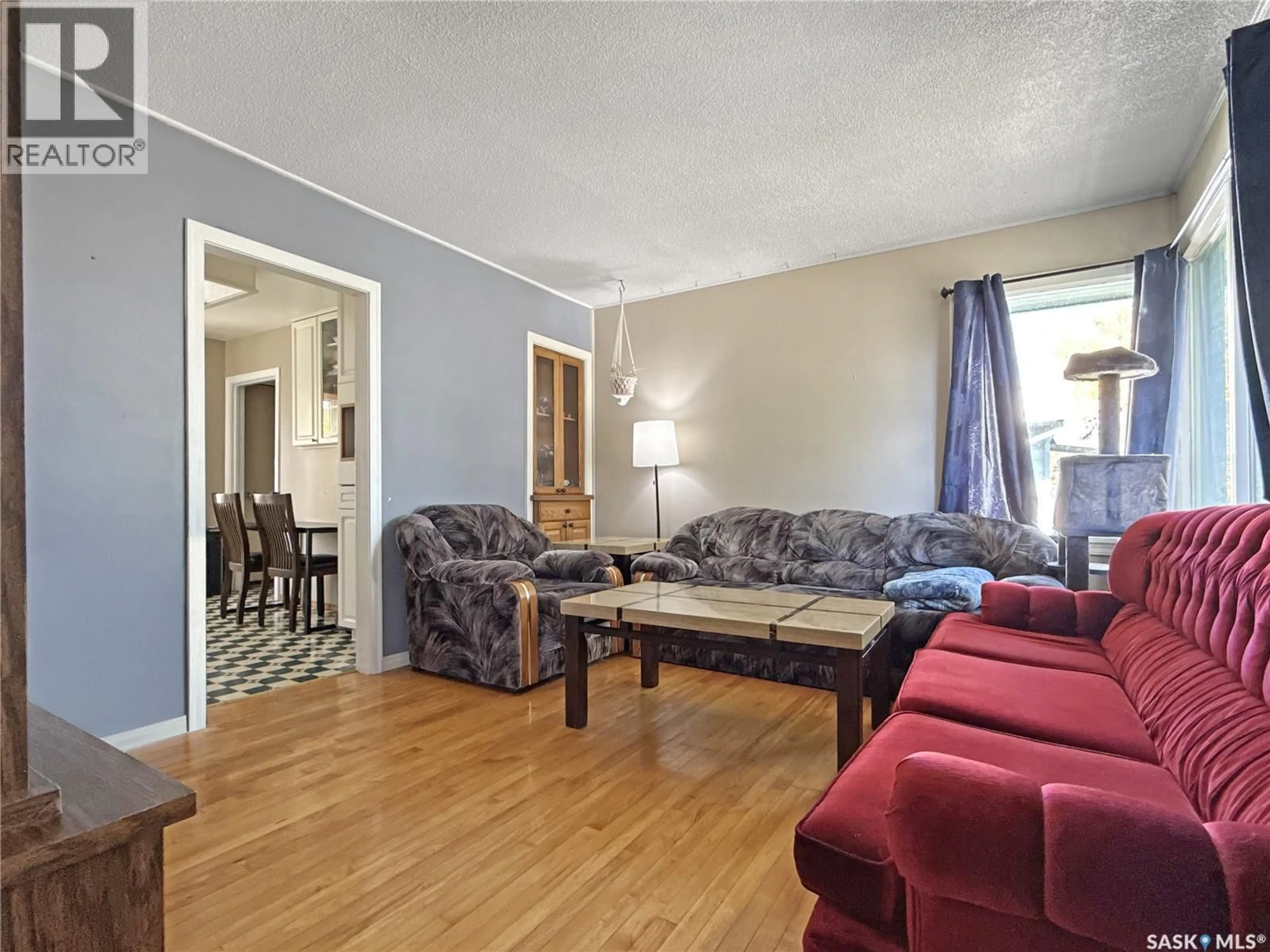 Living room with furniture, wood/laminate floor for 660 3RD AVENUE, Swift Current Saskatchewan S9H2H5