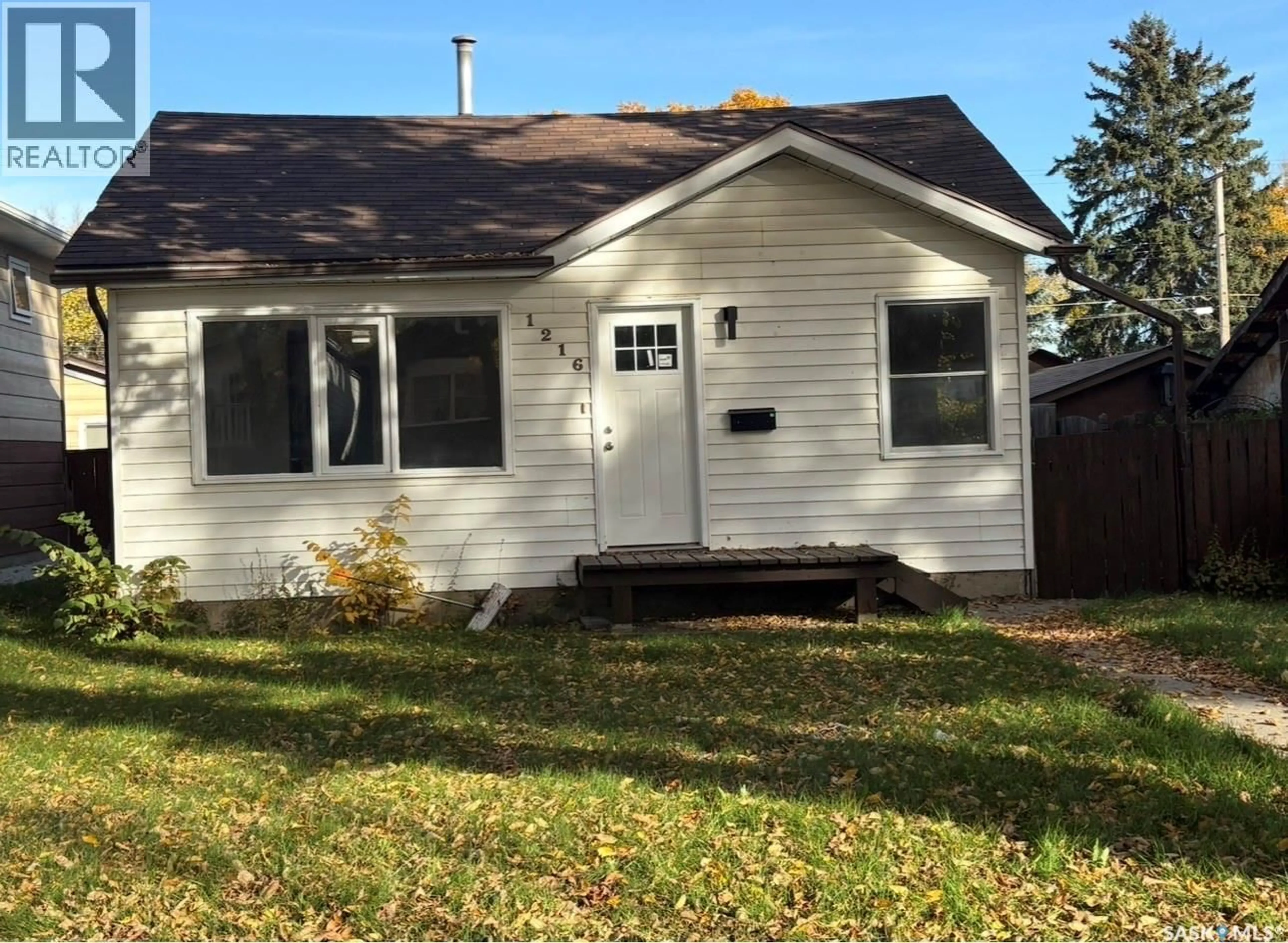 Home with vinyl exterior material, street for 1216 K AVENUE S, Saskatoon Saskatchewan S7M2G7