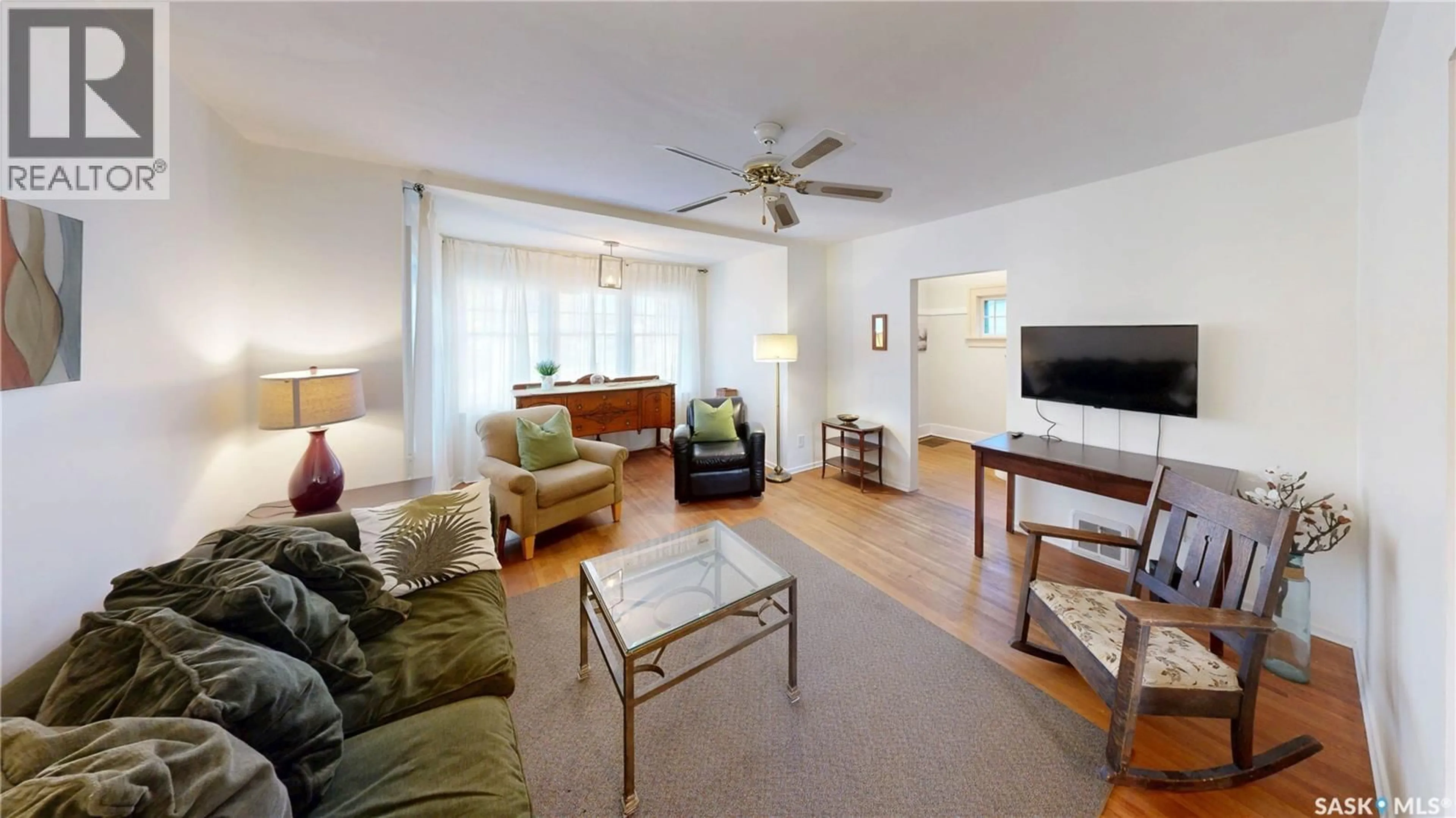 Living room with furniture, wood/laminate floor for 3723 VICTORIA AVENUE, Regina Saskatchewan S4T1M5
